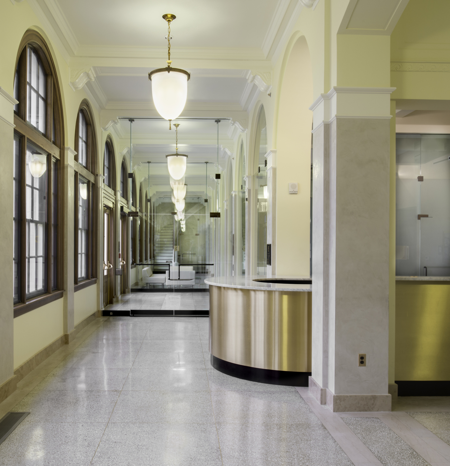 reception desk in front of a mirrored hallway reception desk in front of a mirrored hallway
