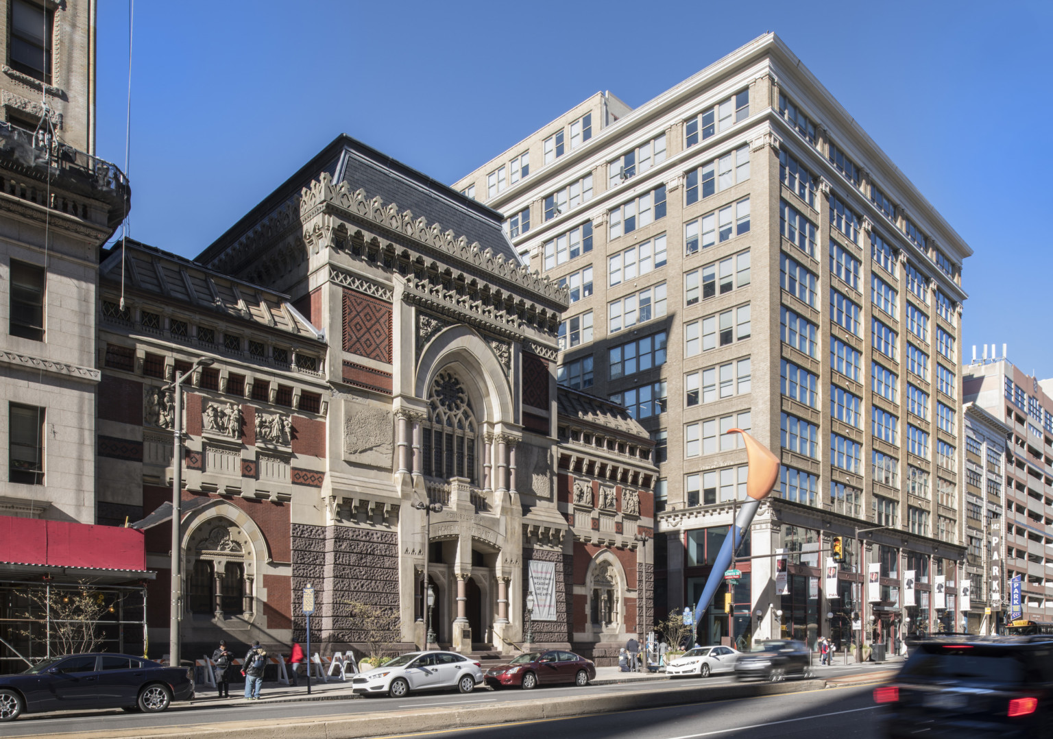 Stone building with gothic windows and sculpted moldings, next to a light stone building, multistory paint brush between Stone building with gothic windows and sculpted moldings, next to a light stone building, multistory paint brush between