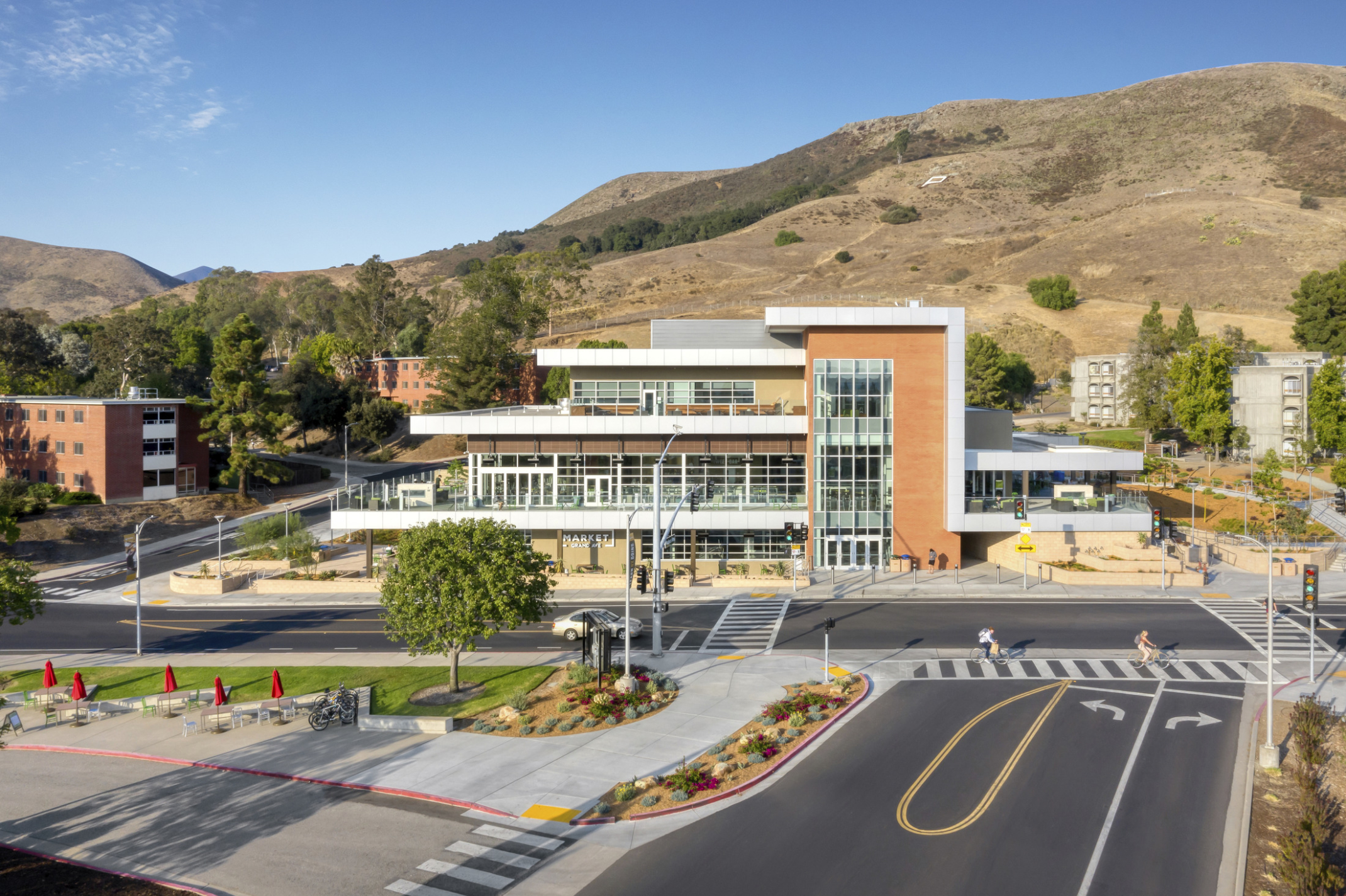 Cal Poly Vista Grande Dining Facility from across an intersection with hill in the background