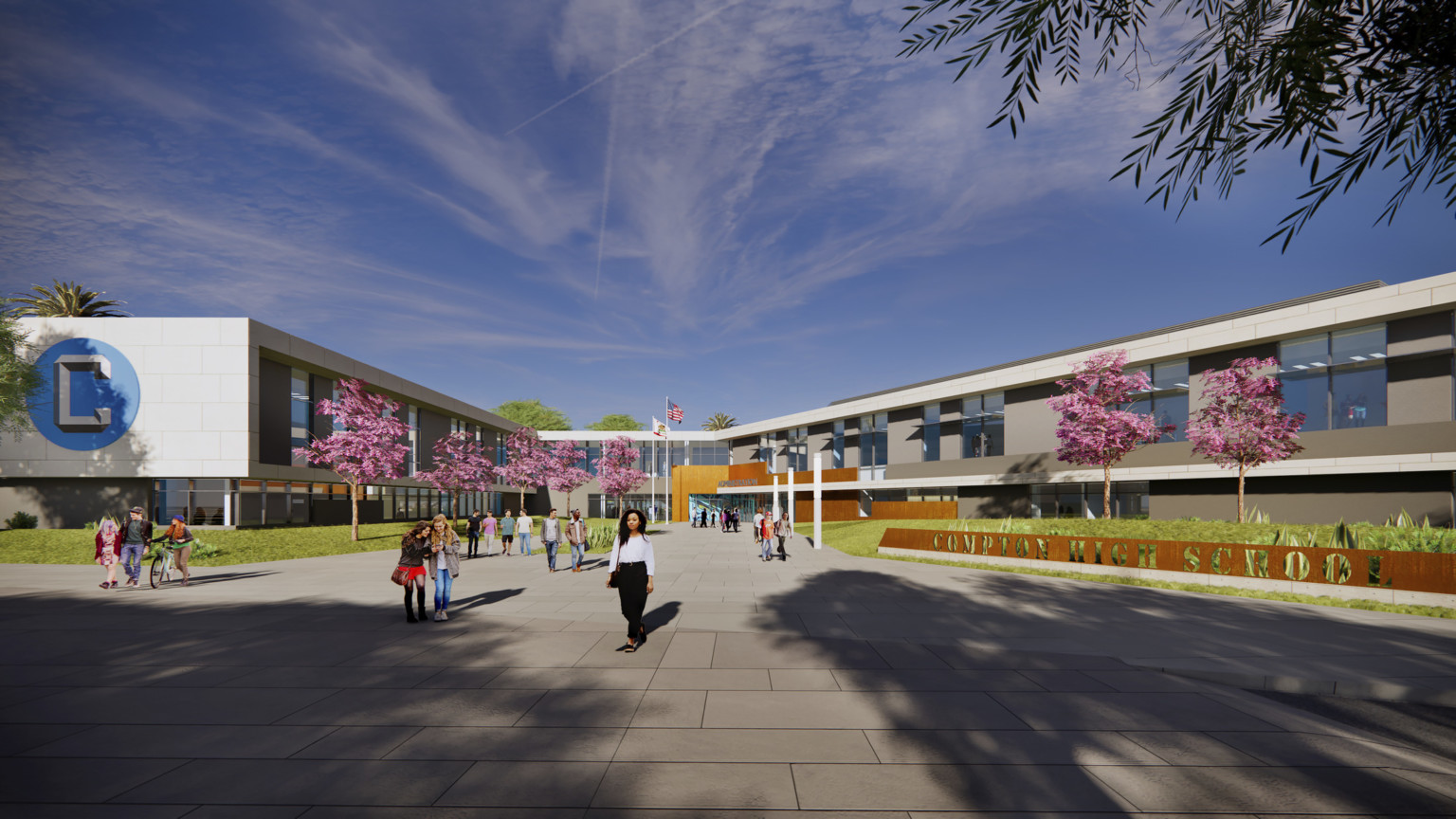 Compton High School entrance. A 2 story angled U shaped building with white wrapping facade. Blue logo on end of extension Compton High School entrance. A 2 story angled U shaped building with white wrapping facade. Blue logo on end of extension