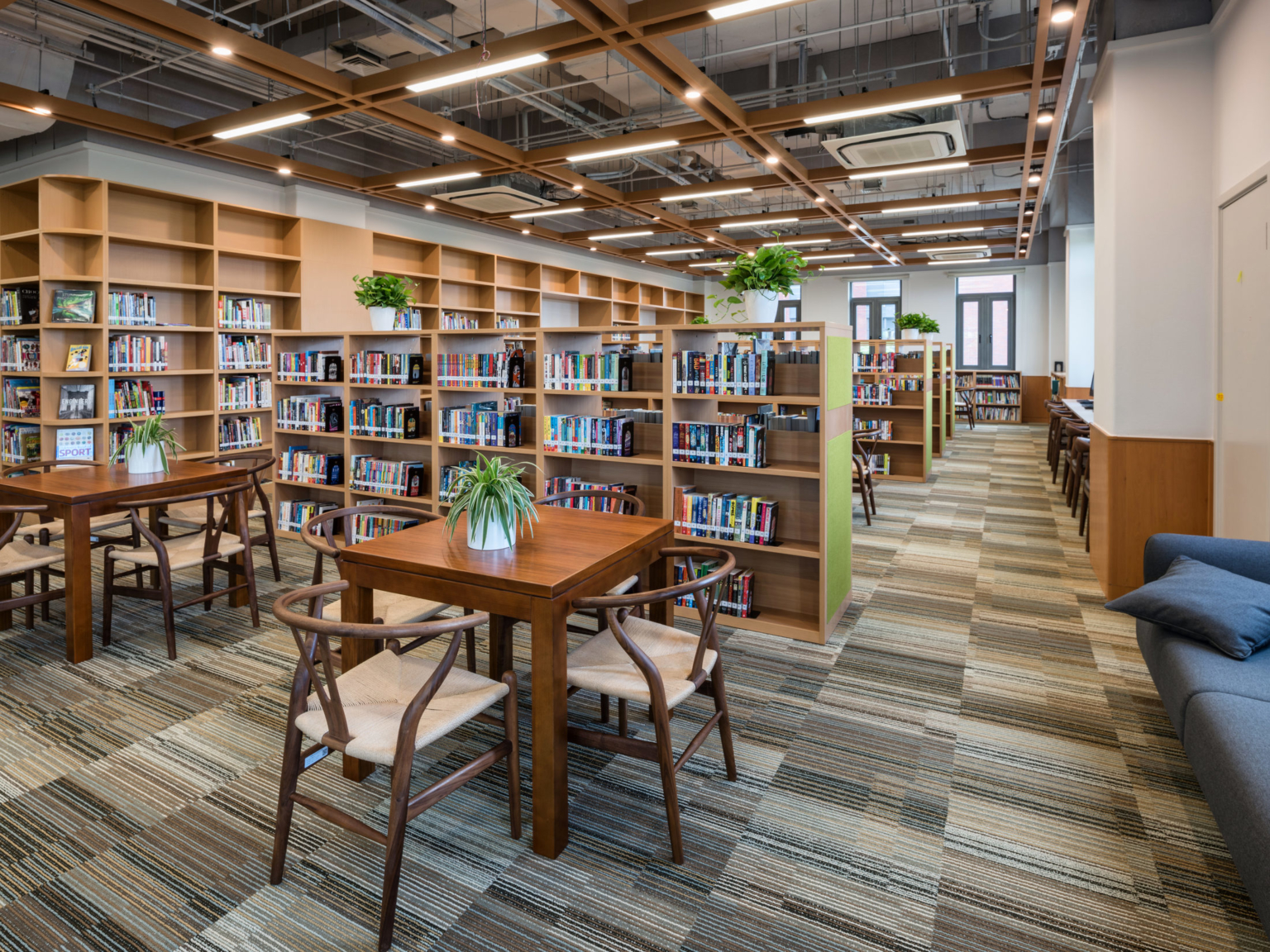 library with bookshelves and tables at Huili International School