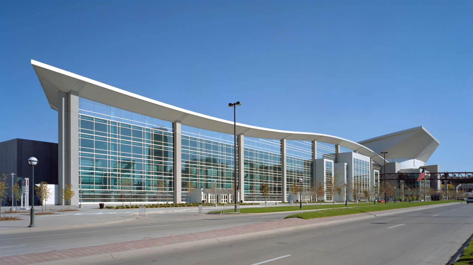 outdoor view of building with large windows and curved roof outdoor view of building with large windows and curved roof