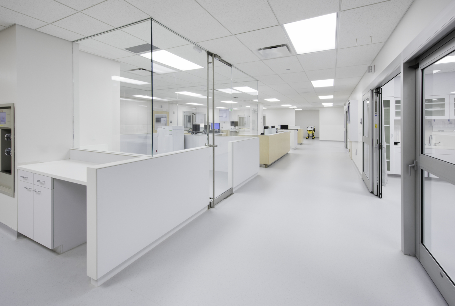 a corridor that separates nursing stations from patient rooms