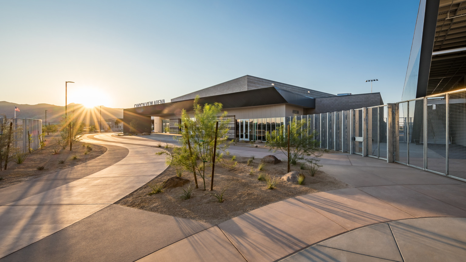 a steel and mason building with a sunset in the mountain background a steel and mason building with a sunset in the mountain background