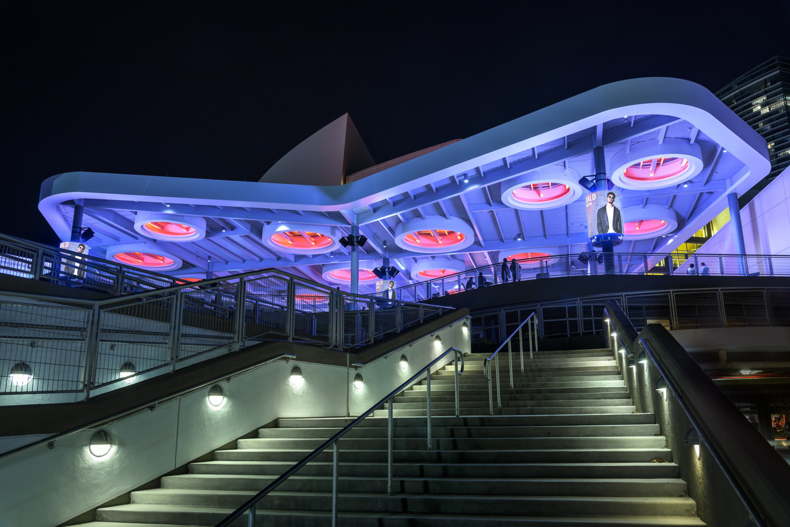 FTX Arena, home of the Miami Heat, solar canopy on the East Plaza illuminated purple with red recessed solar skylight rings