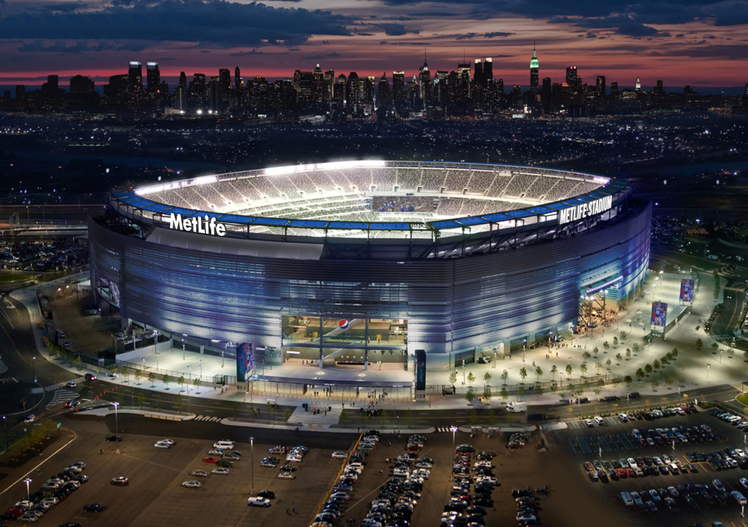 MetLife Stadium, home to the New York Jets and Giants, illuminated at night, encircled by LED solar panels and blue facade