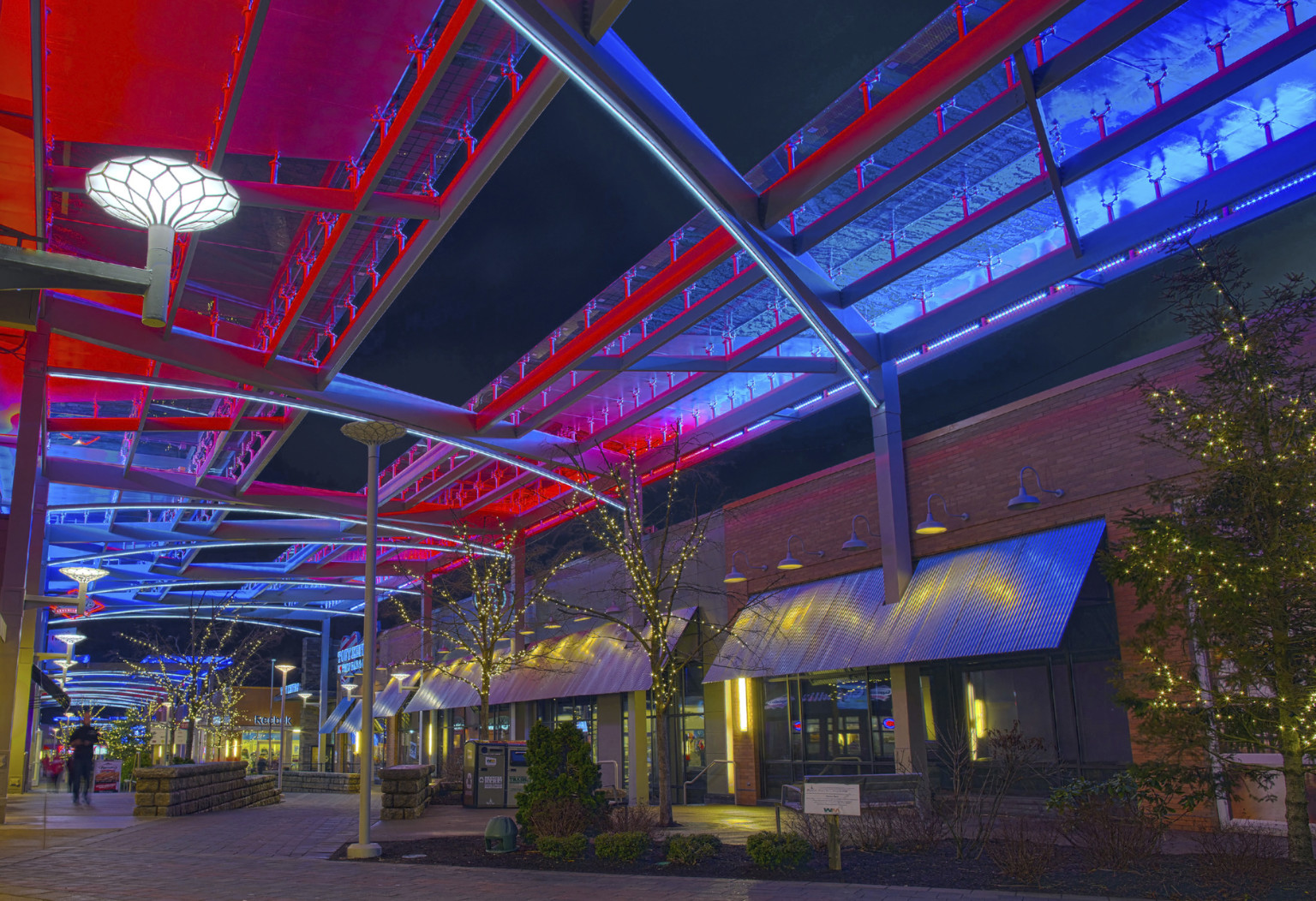 Patriot Place, located in New England Patriot's Gillette Stadium, walkway lined with red and blue LED display canopy