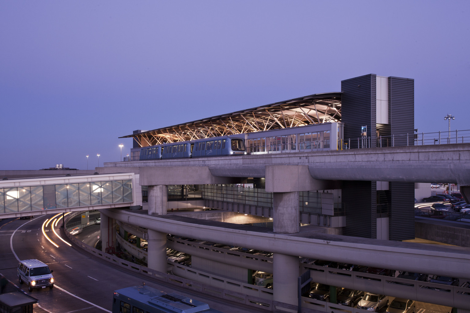 San Francisco International Airport AirTrain Station. Elevated railway with skywalk over road connecting to 1st floor