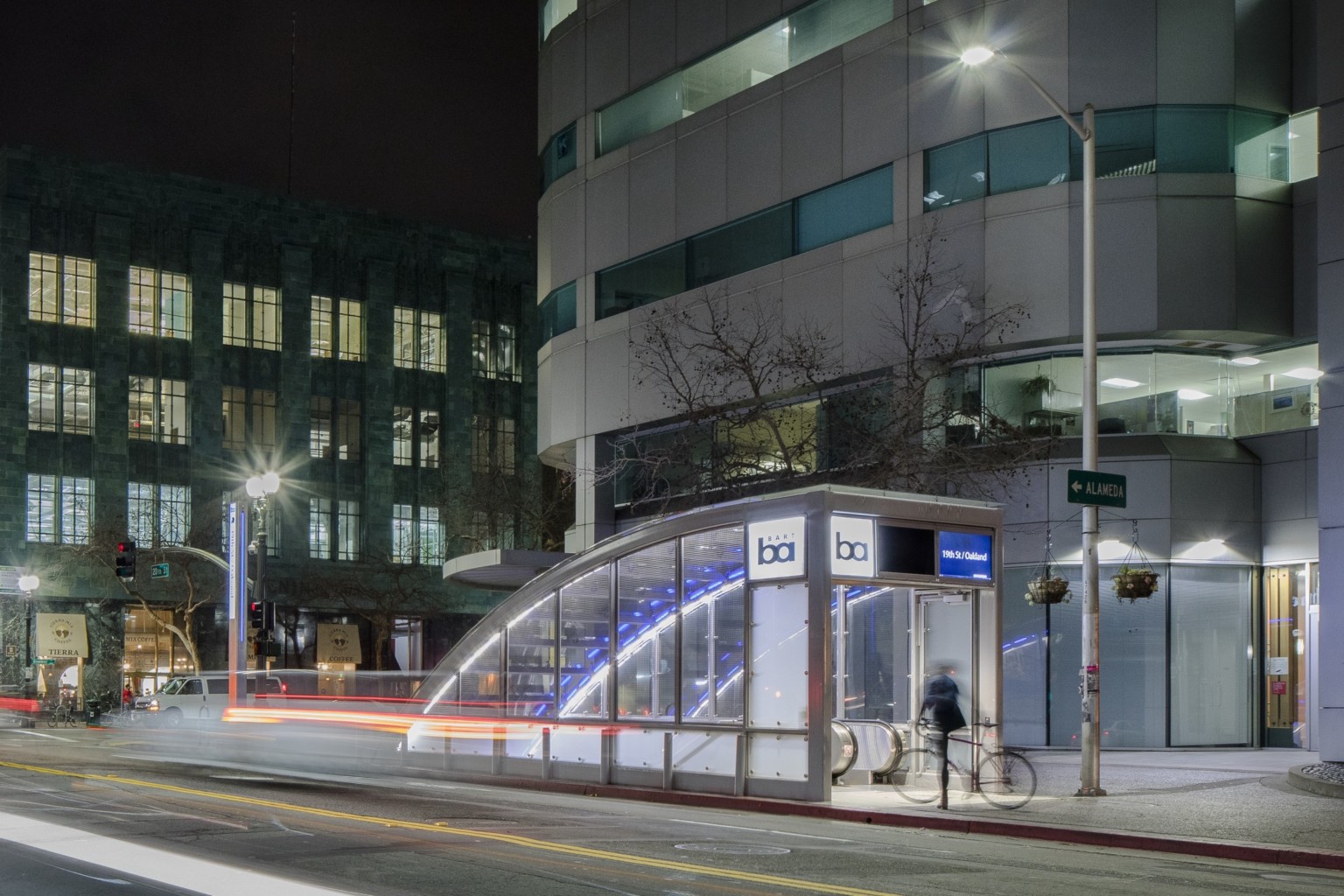 Bay Area Rapid Transit station street level entrance at 19th Street and Oakland. A blue and glass shelter leading underground
