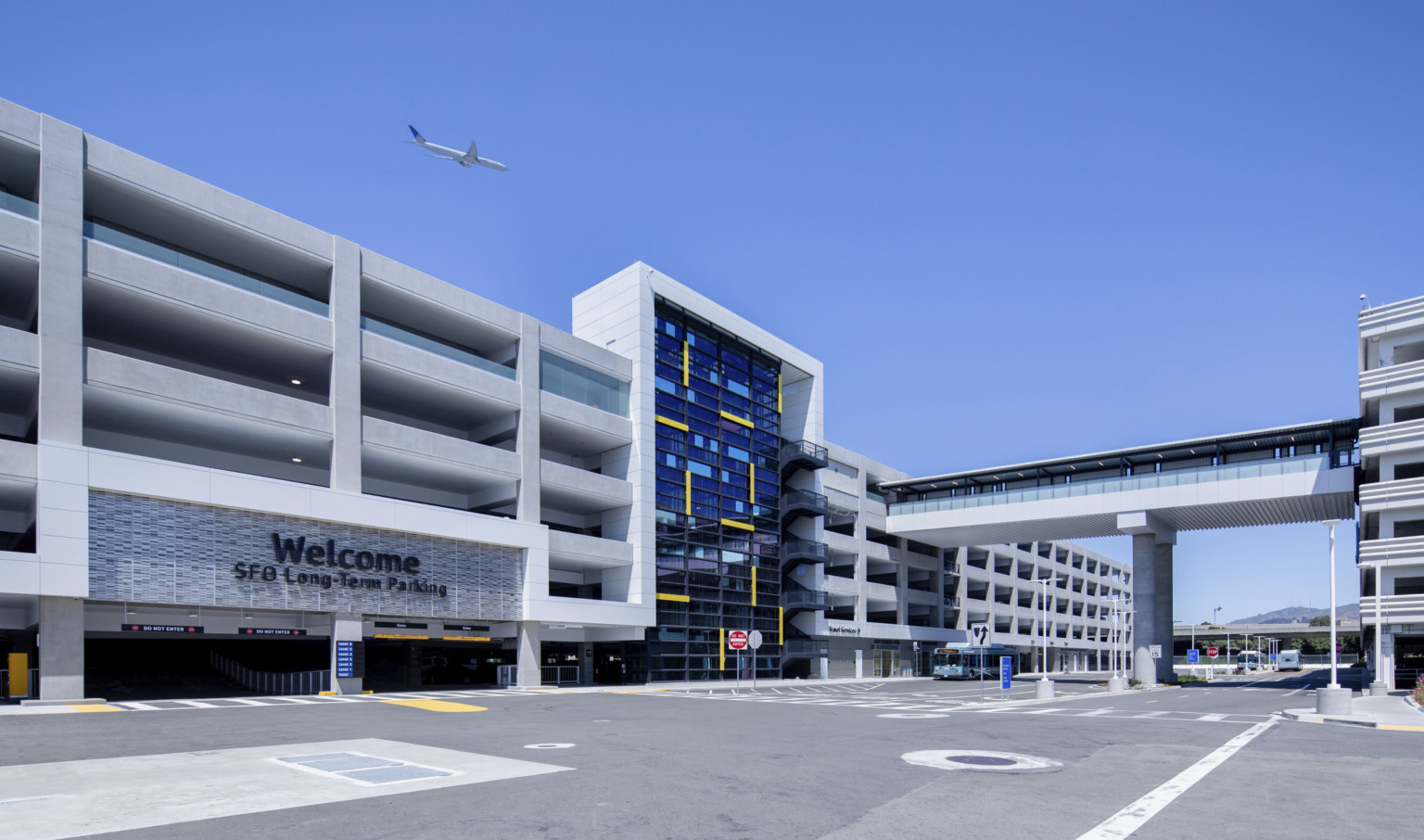 San Francisco International Airport Long Term Parking Garage, 6 stories with glass facade center and stairs. Entrance to left