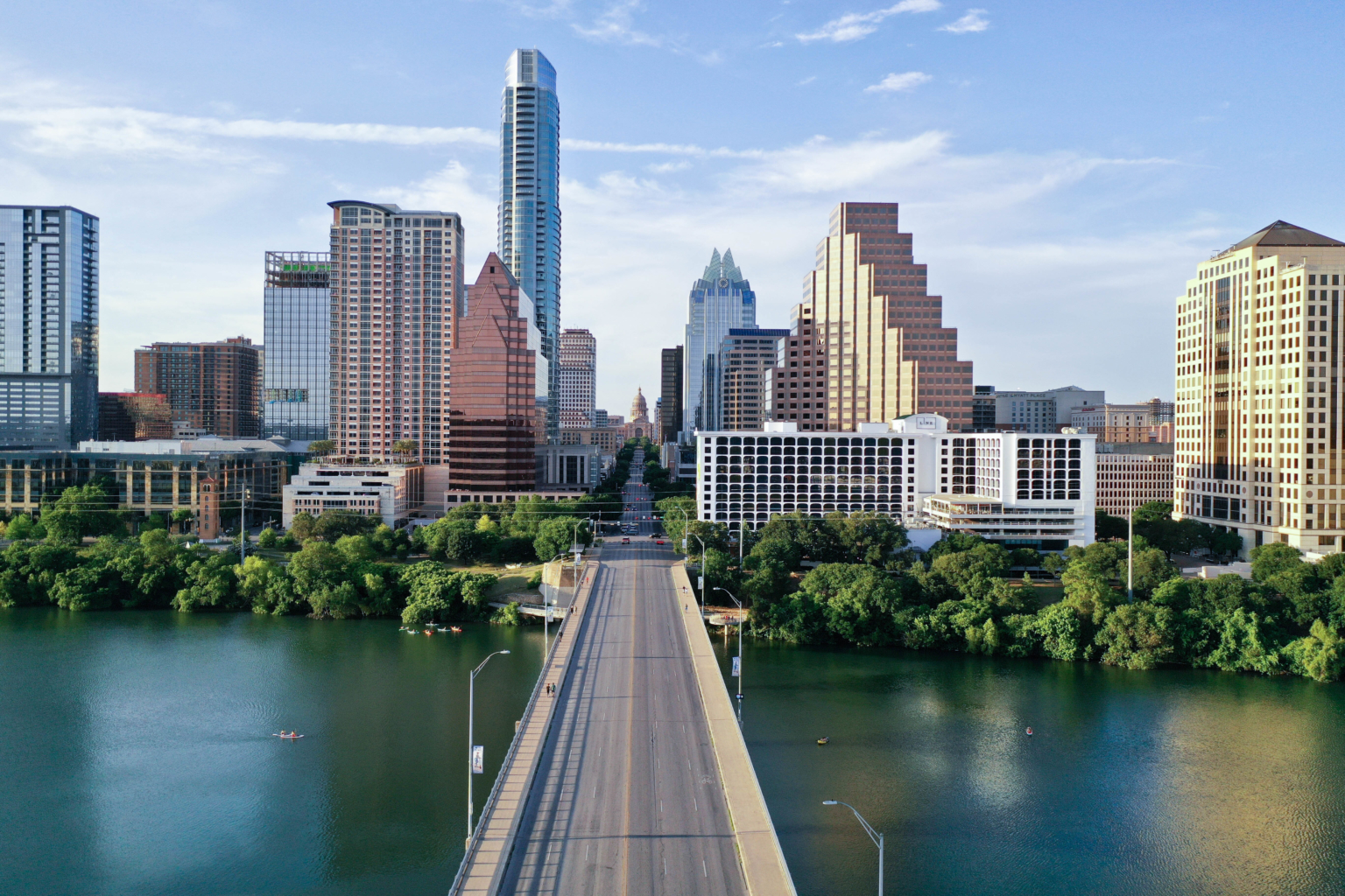 city scape of the austin texas skyline with the lake in the foreground