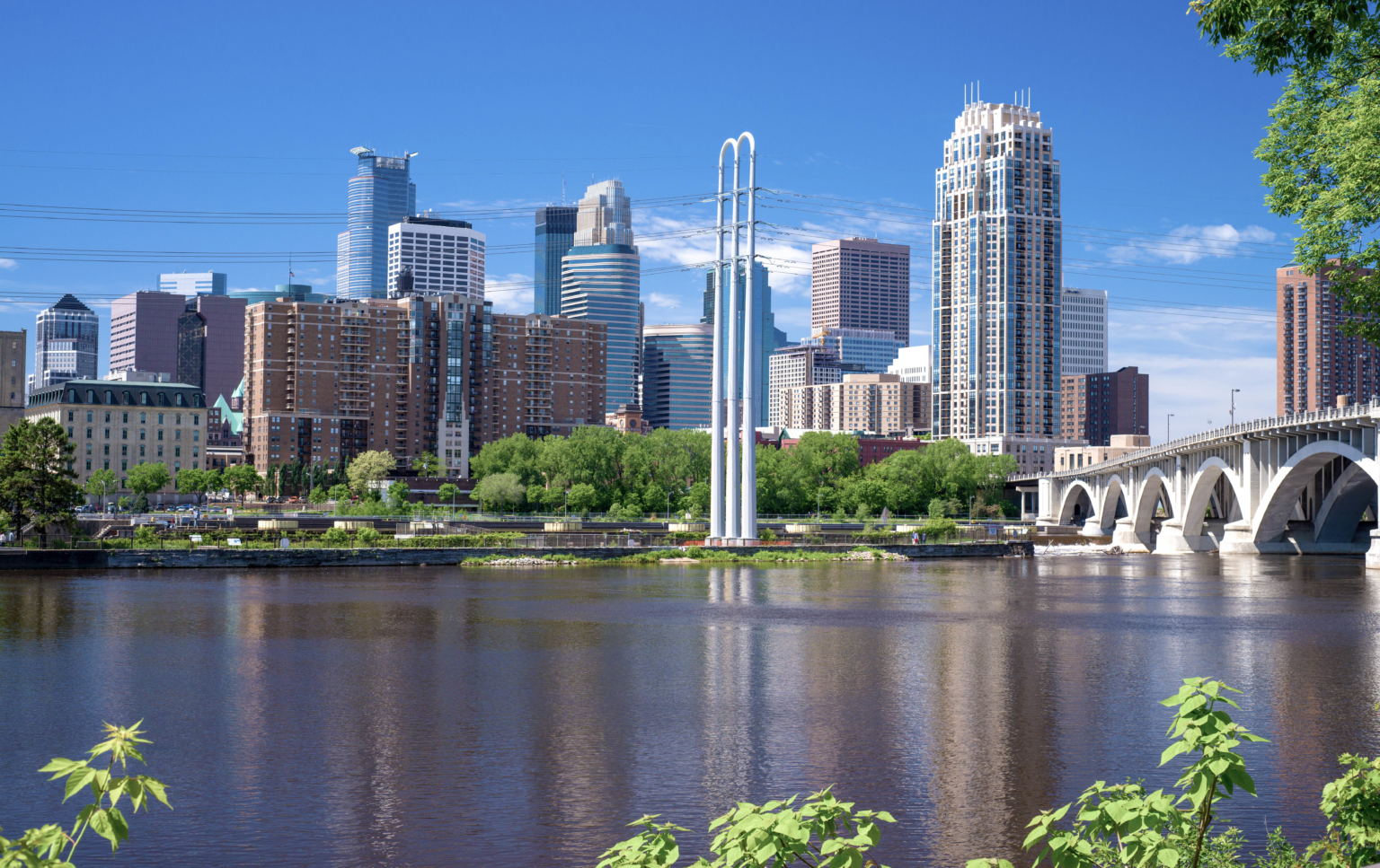 the mississippi river in the foreground of the downtown minneapolis skyline