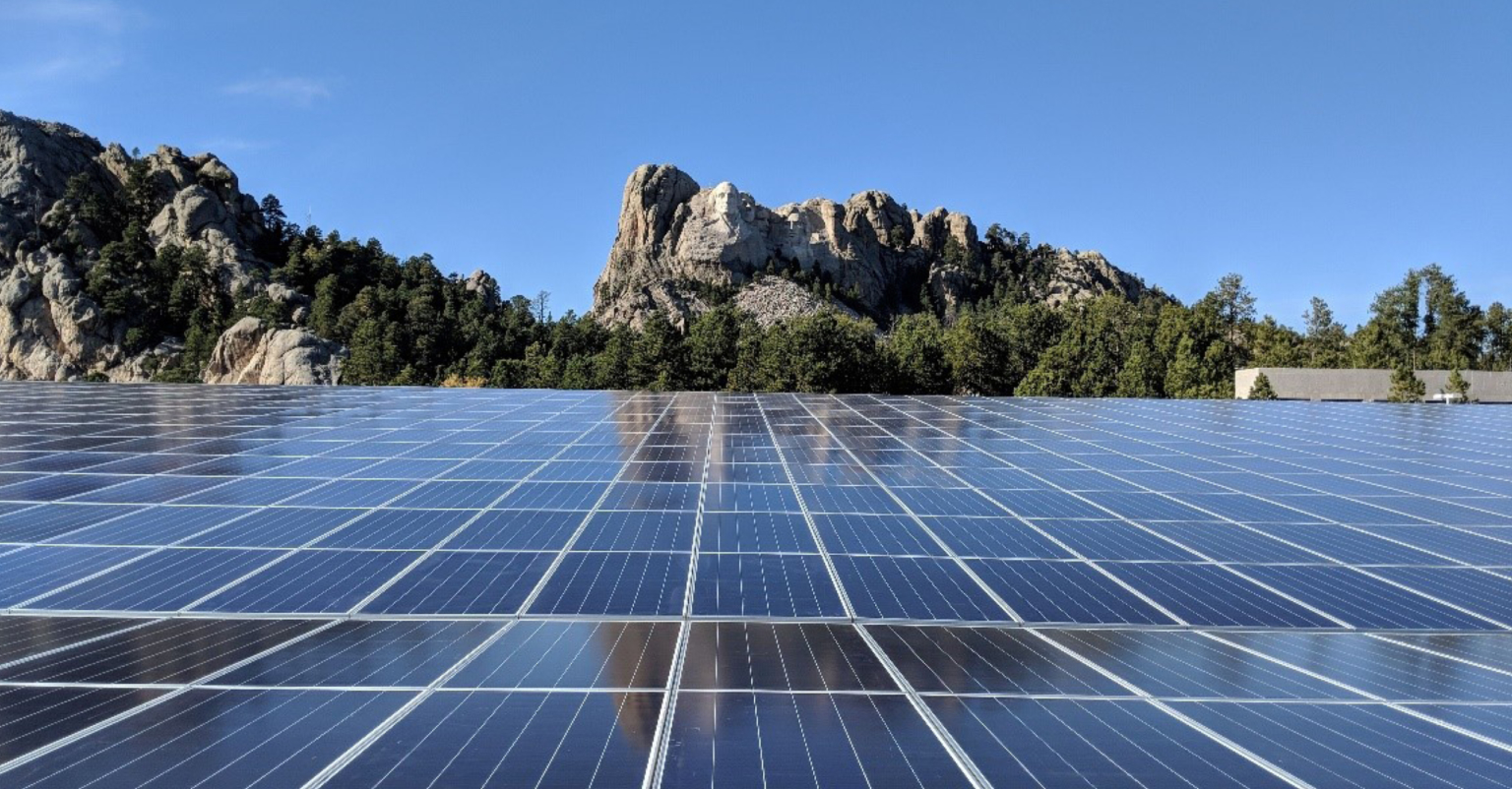 solar panels with mount rushmore in the background
