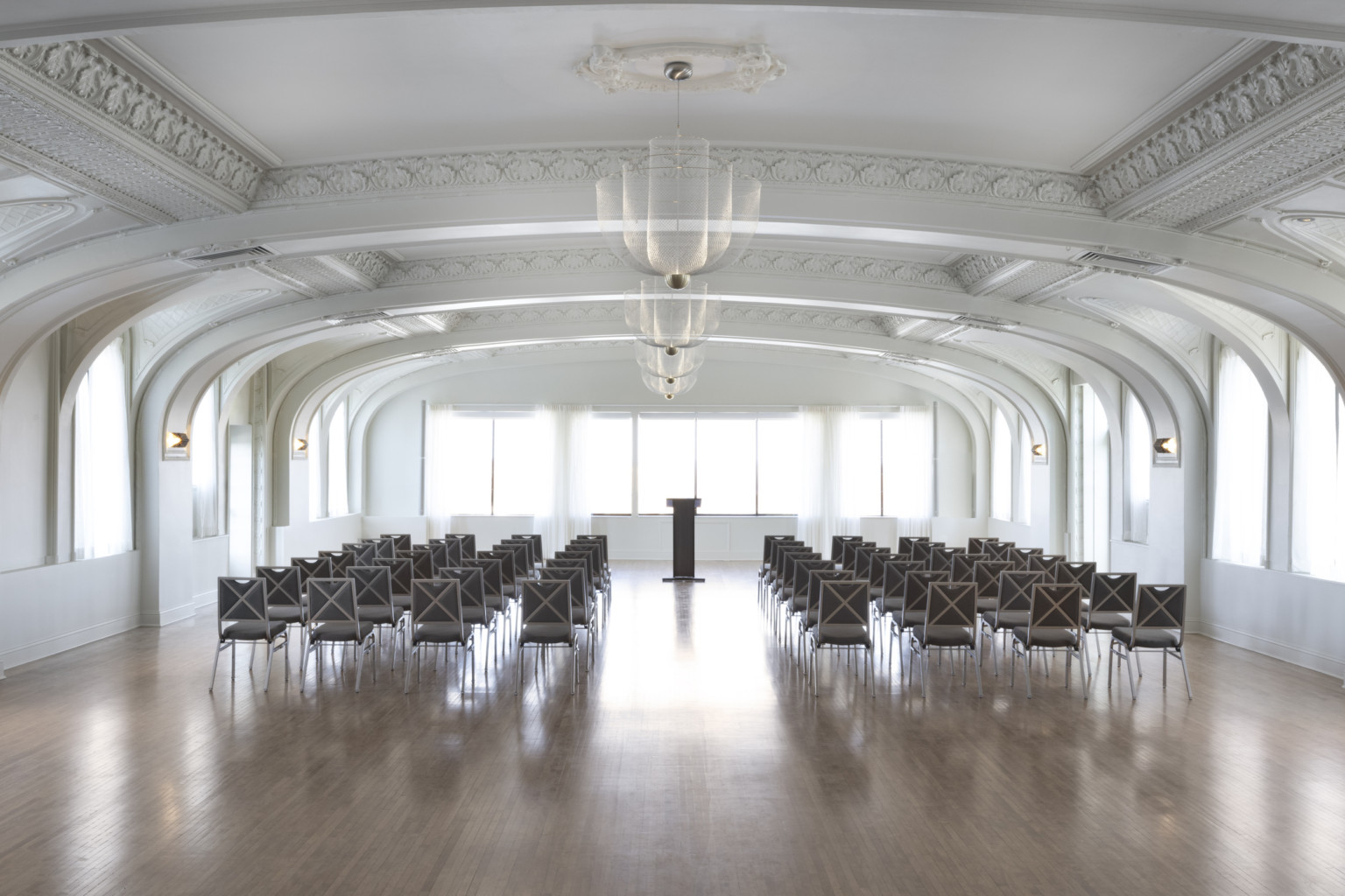 ballroom with white arched ceilings