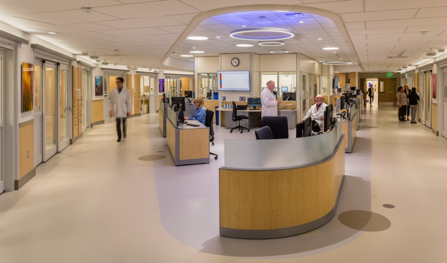 a healthcare corridor divided by a triangular nurses station