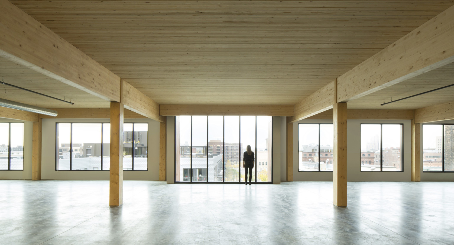 mass timber floor plate looking toward floor to ceiling windows mass timber floor plate looking toward floor to ceiling windows