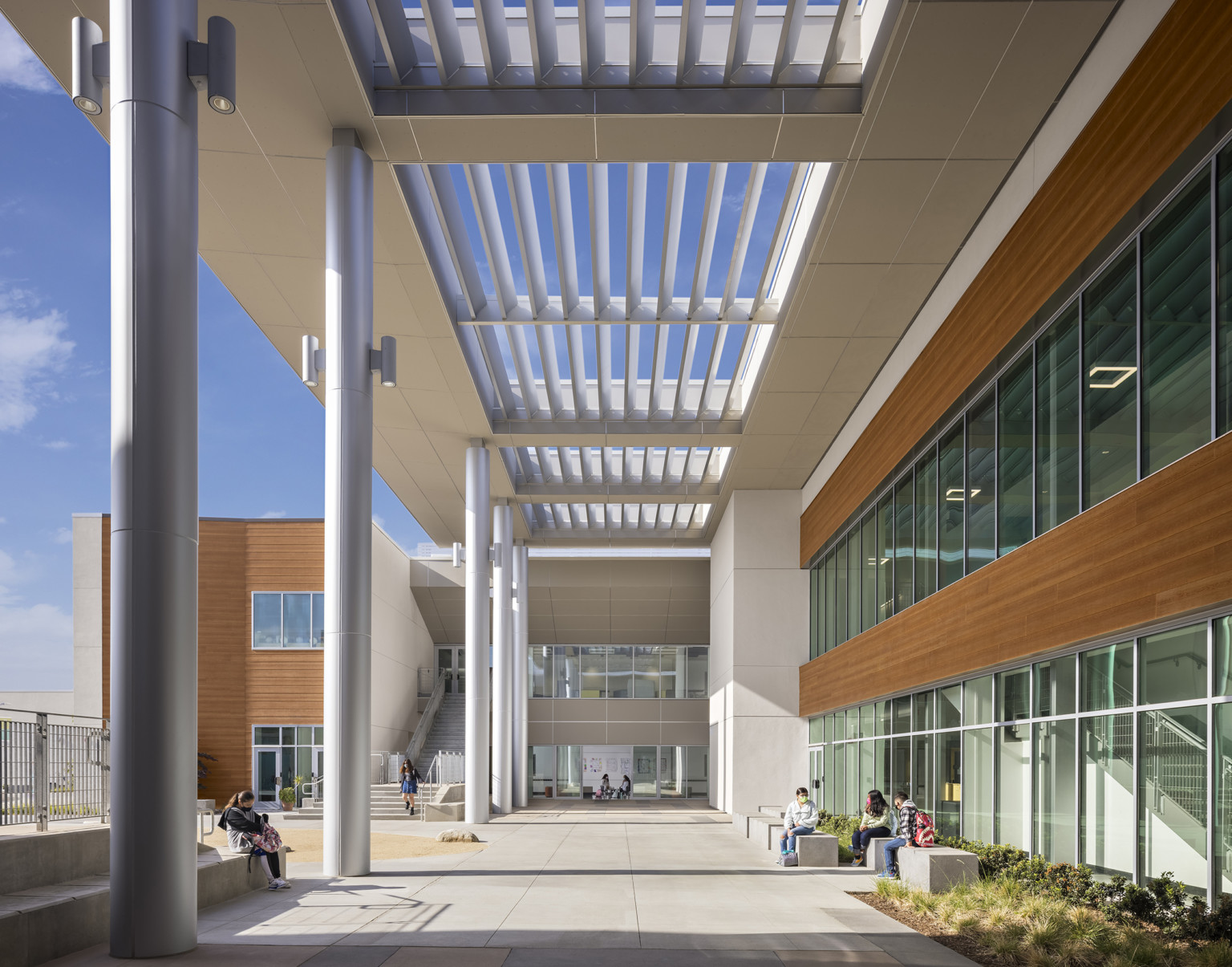 louvered canopy shades a building perimeter walkway