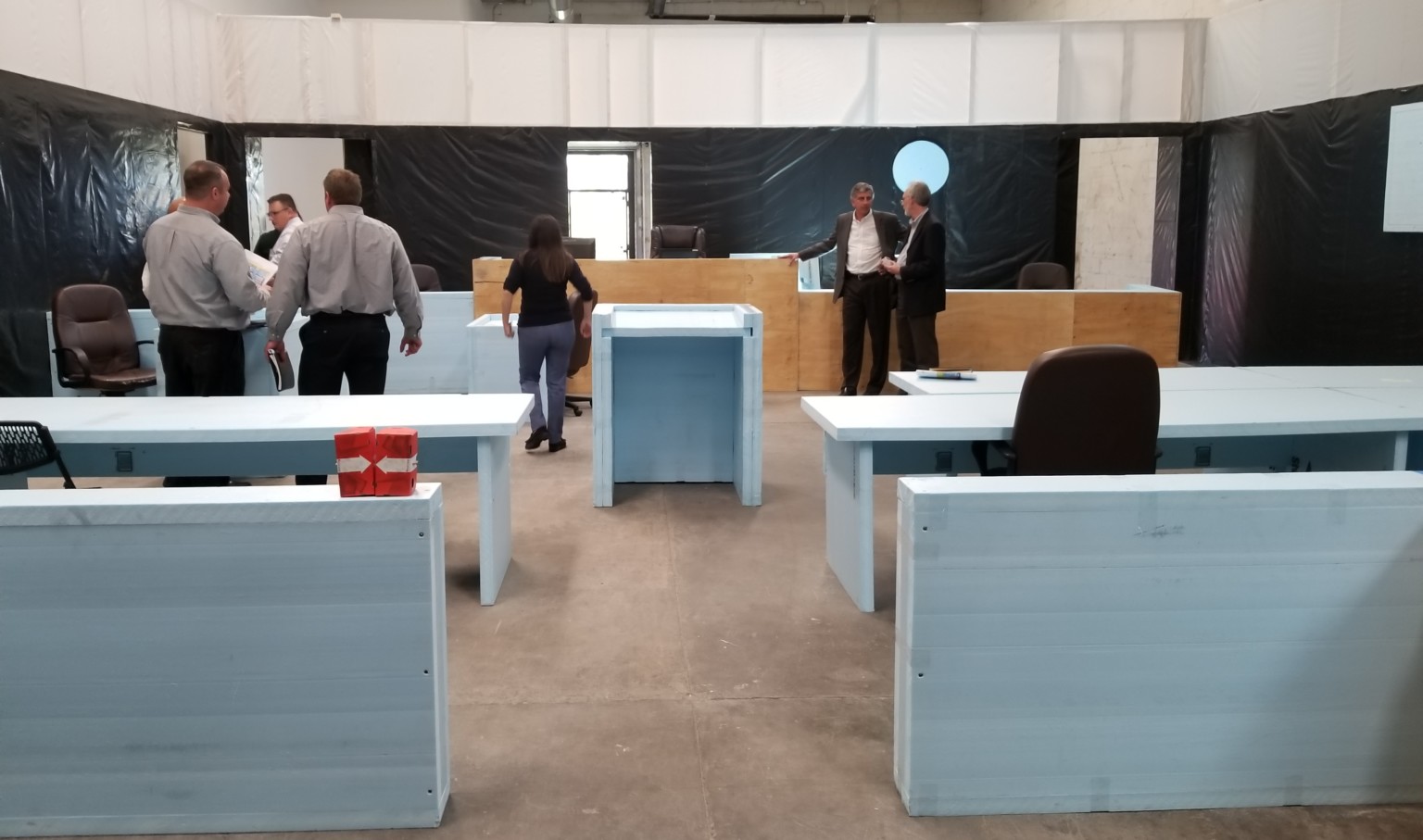 functional mockup of courtroom with people studying the space