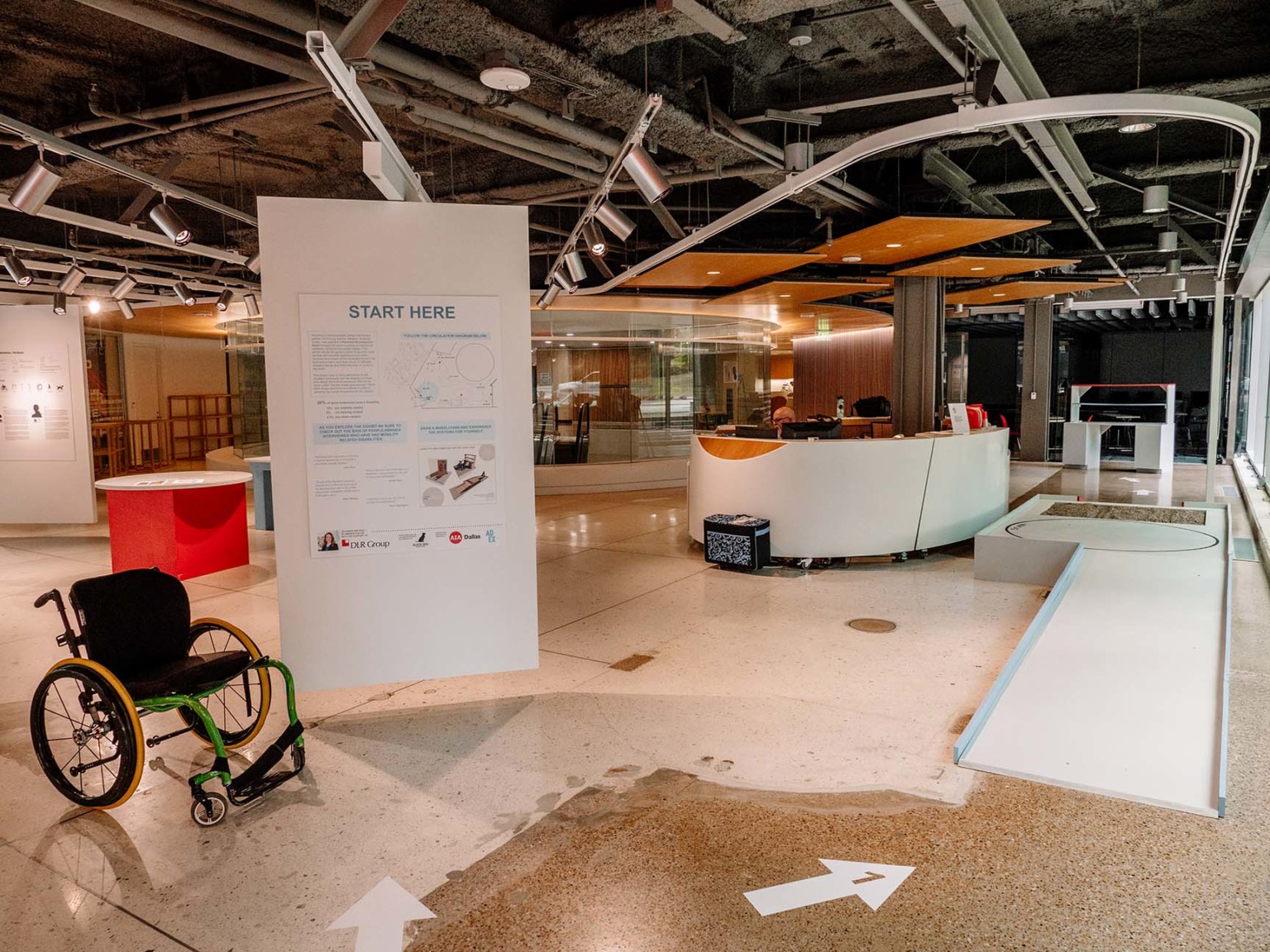 ADA accessibility design exhibit with a wheel chair ramp and plaques on display