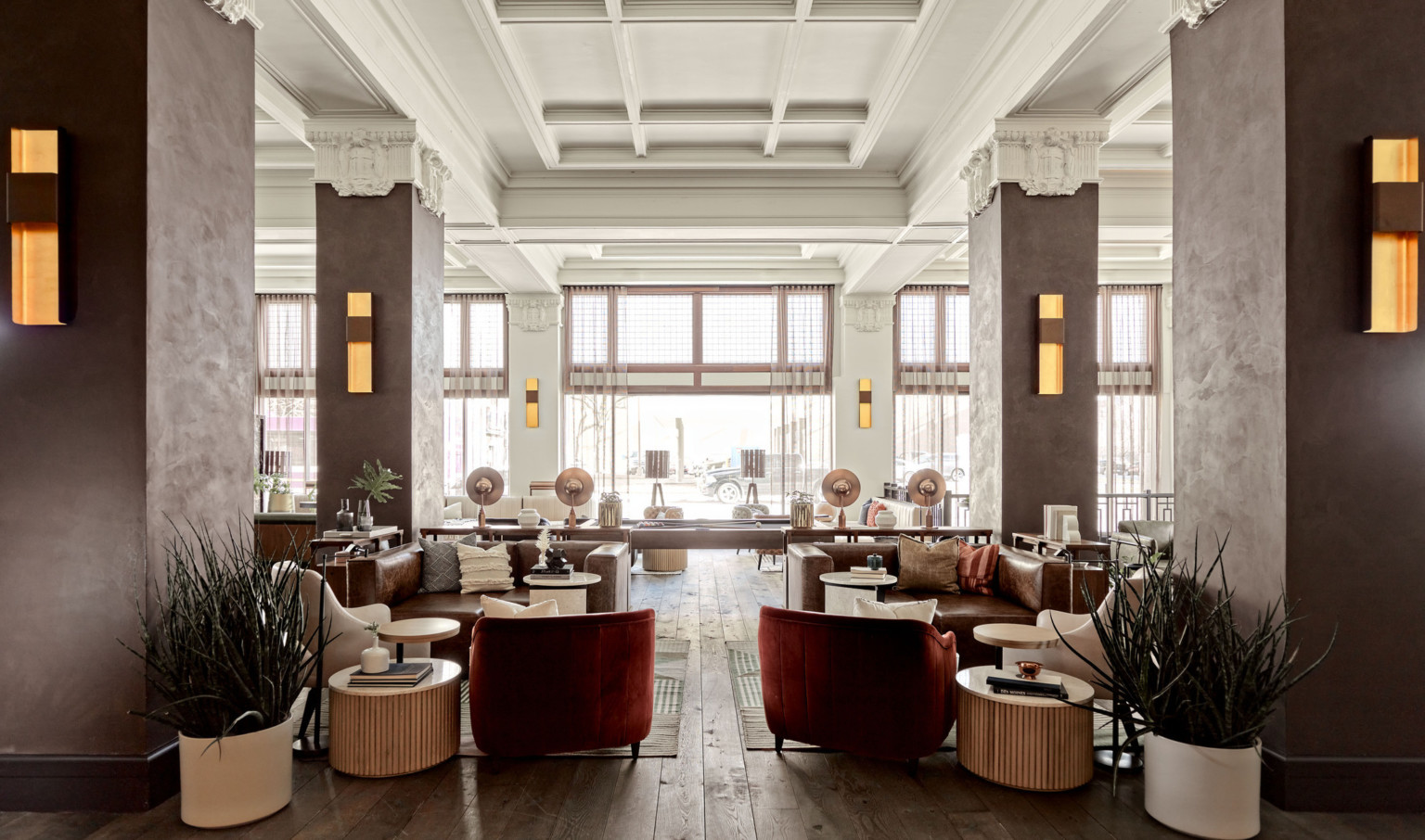 Seating area in the with wood pillars and white stone capitals in white room with recessed ceiling details. Pool table center Seating area in the with wood pillars and white stone capitals in white room with recessed ceiling details. Pool table center