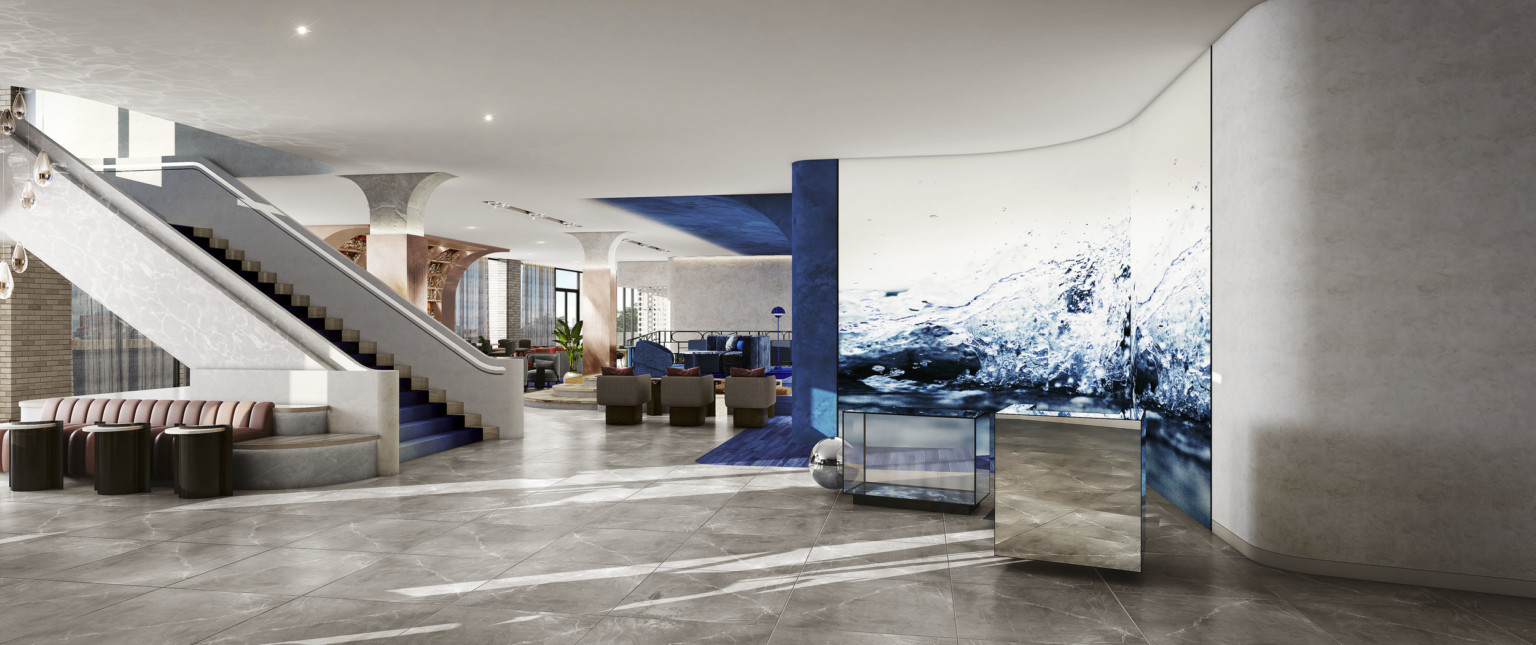 Hotel lobby with abstracted water mural and blue and white walls. Grand staircase left, in front of seating and stone columns