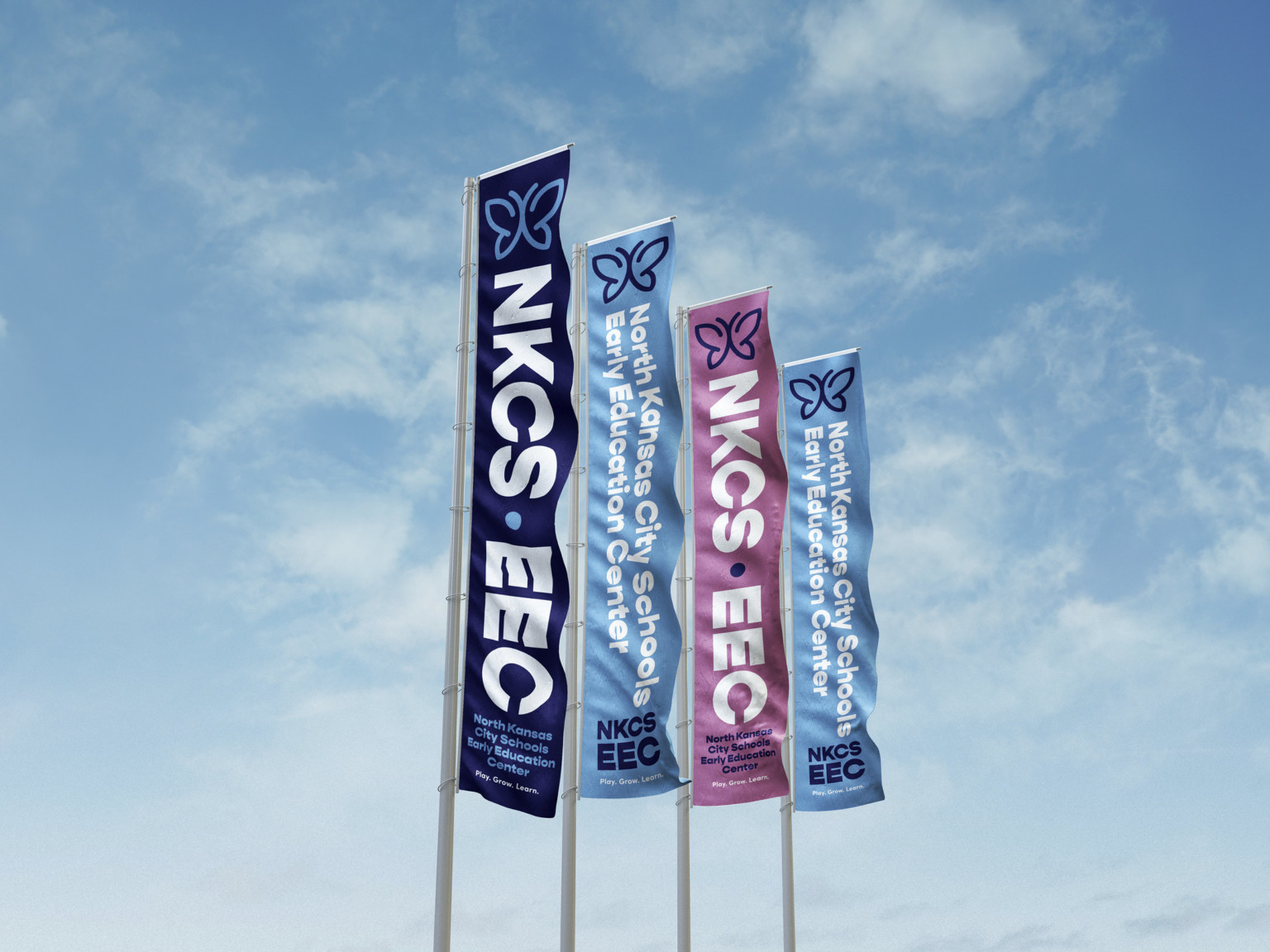 4 blue and purple vertical banners with white lettering against a blue sky