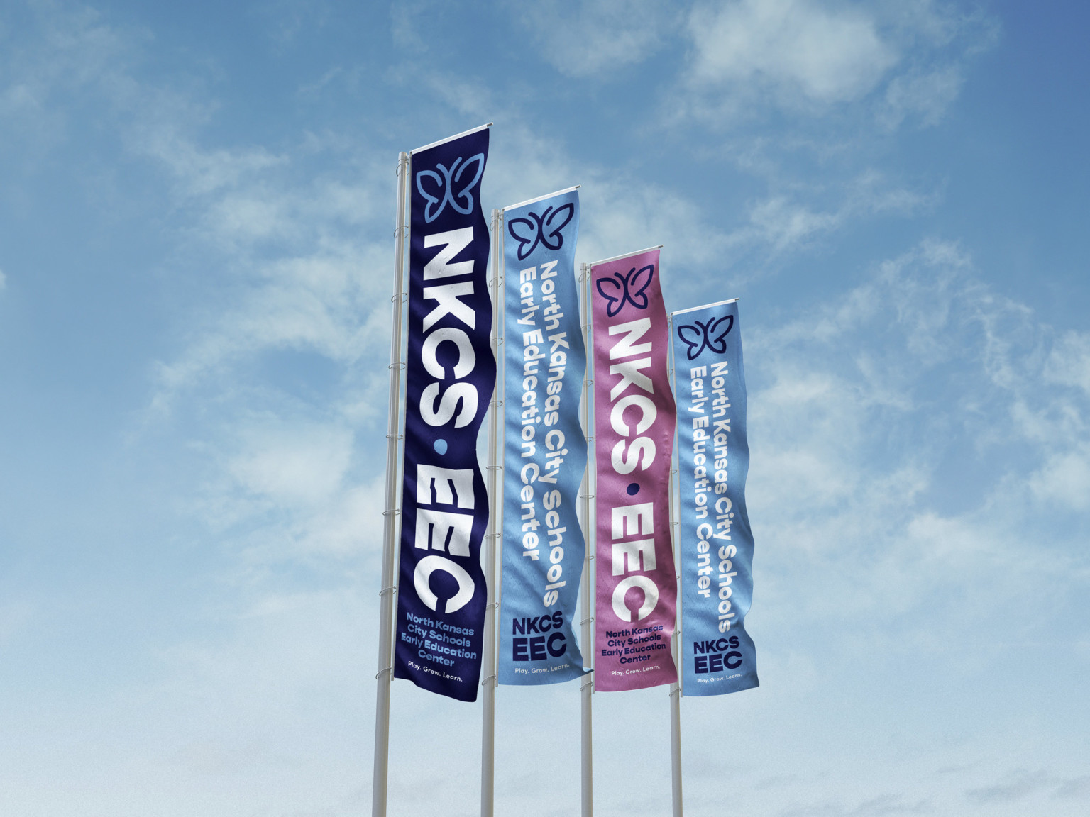 4 blue and purple vertical banners with white lettering against a blue sky 4 blue and purple vertical banners with white lettering against a blue sky