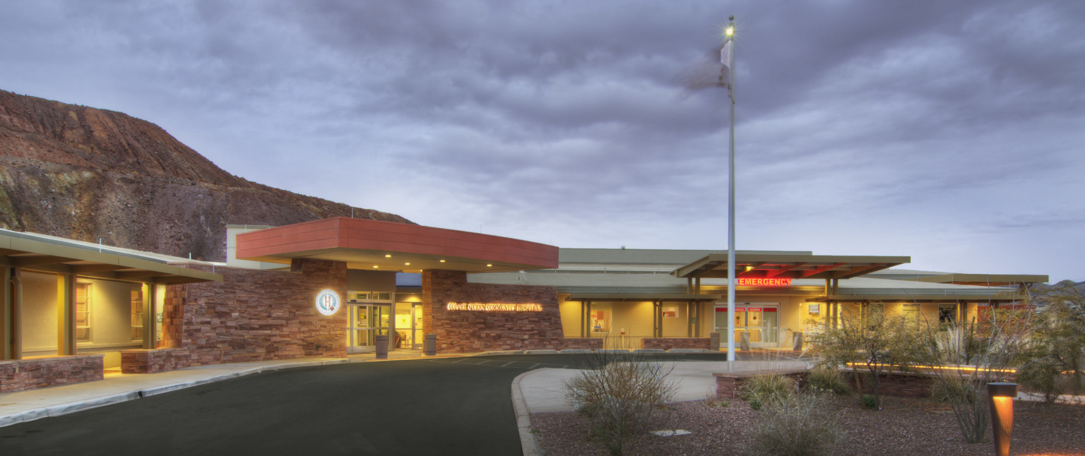 Rendering of front of building, general entrance left with logo and name illuminated on each side, emergency room entry right