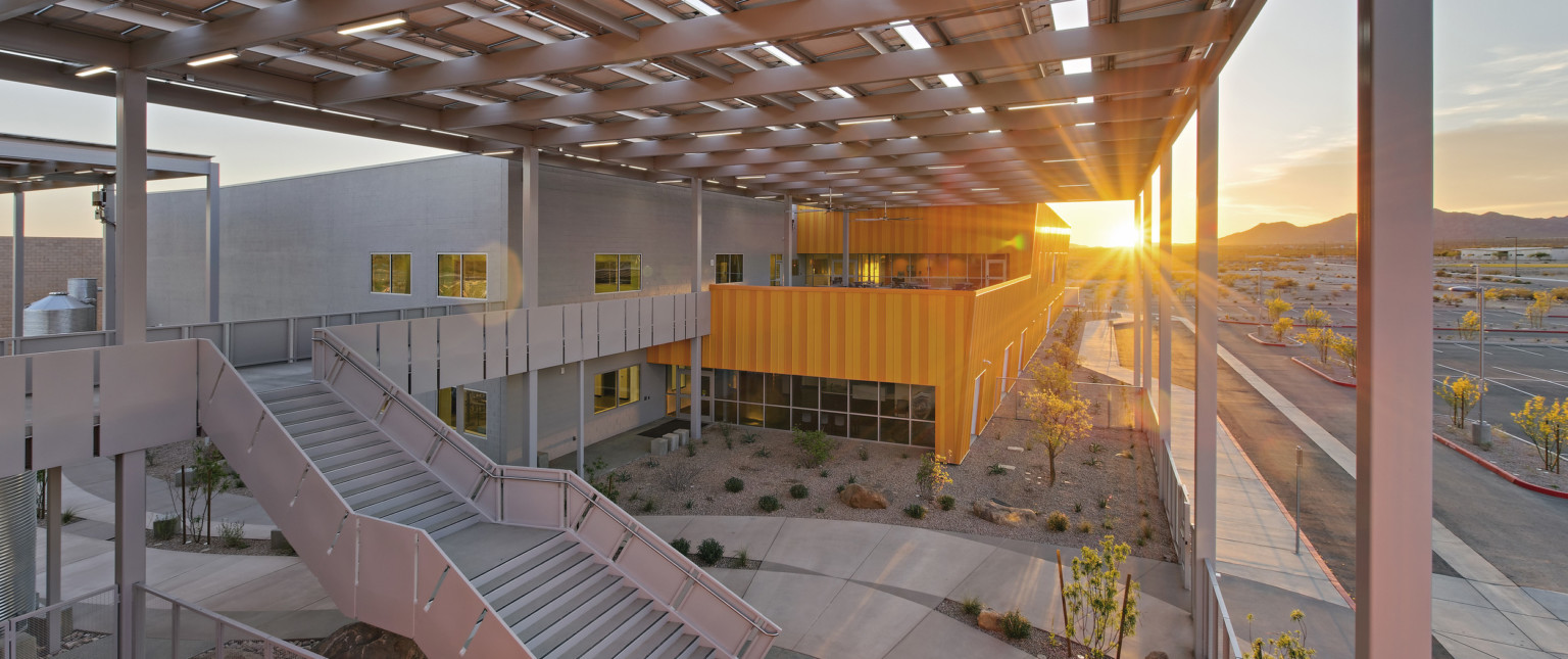 Western Maricopa Education Center (West-MEC) Southwest campus entrance. A 2 story grey and yellow building with solar canopy