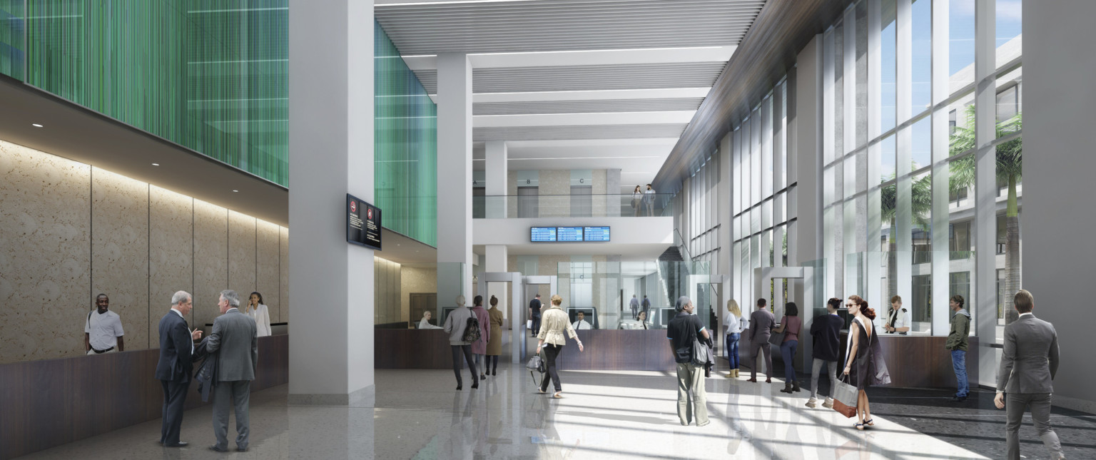 Interior lobby with floor to ceiling windows, right. Left, a wood half wall below green facade overhang, behind white pillars