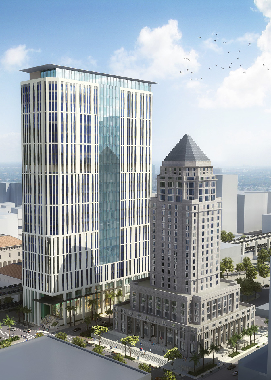 Aerial view of courthouse from the front corner. White facade sides with long thin windows. Floor to ceiling windows at top