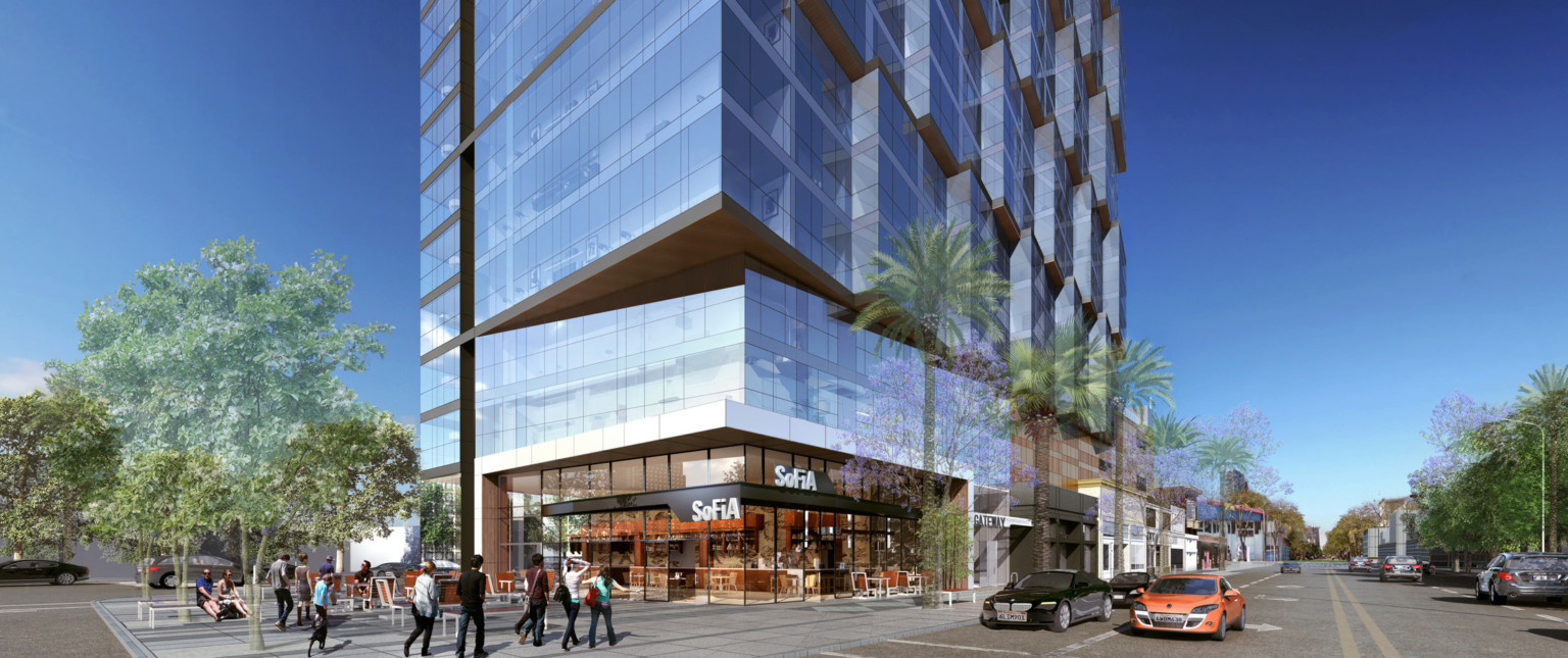 Double height storefront at corner of 1st floor below a recessed angle of 2nd and 3rd floor. Above, a stepped glass wall