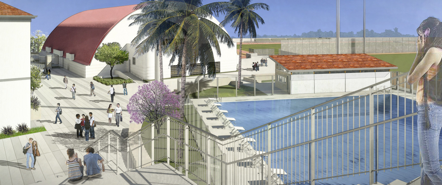 View from the top of stairs left of pool with diving platforms. Stairs lead to courtyard and white arch shaped building