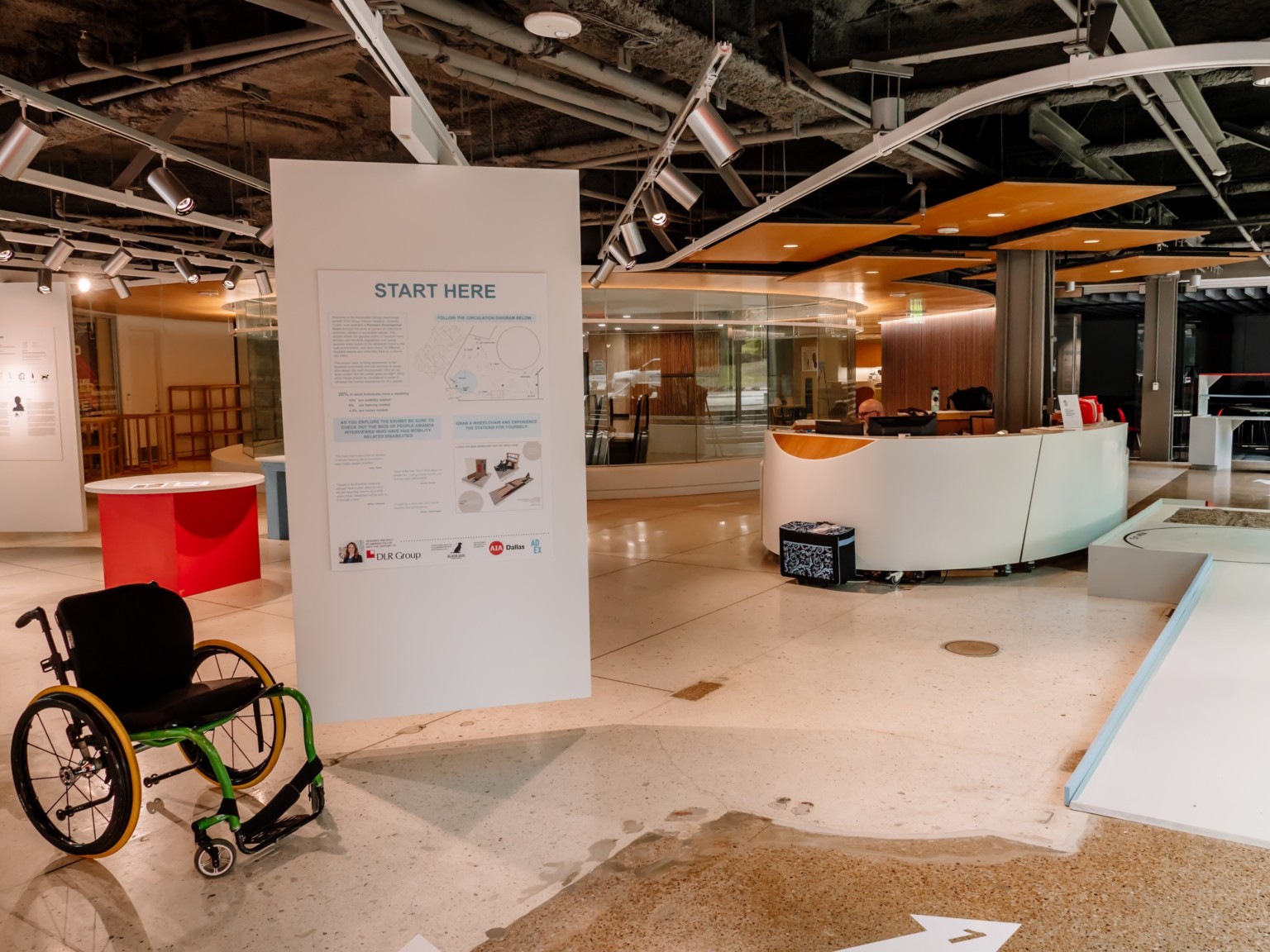 ADA accessibility design exhibit with a wheel chair ramp and plaques on display
