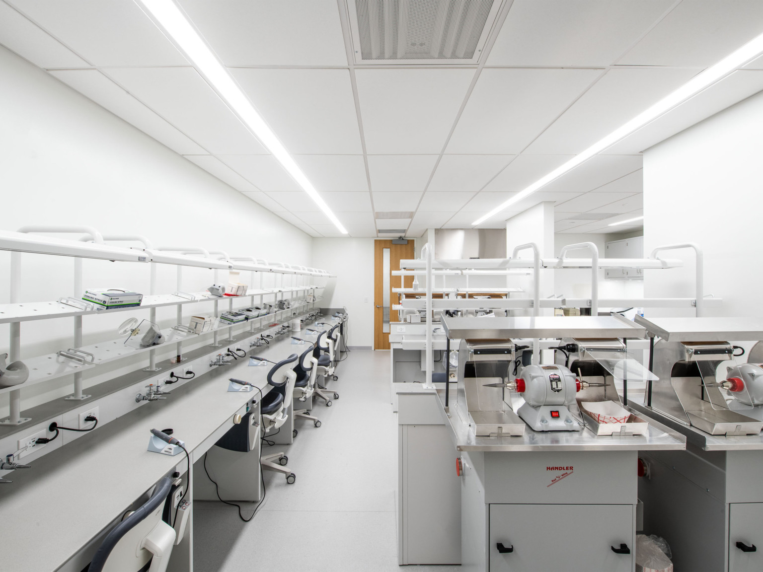 Learning lab, a grey table lines the left wall with equipment at each station. Larger tools are at stations to the right.