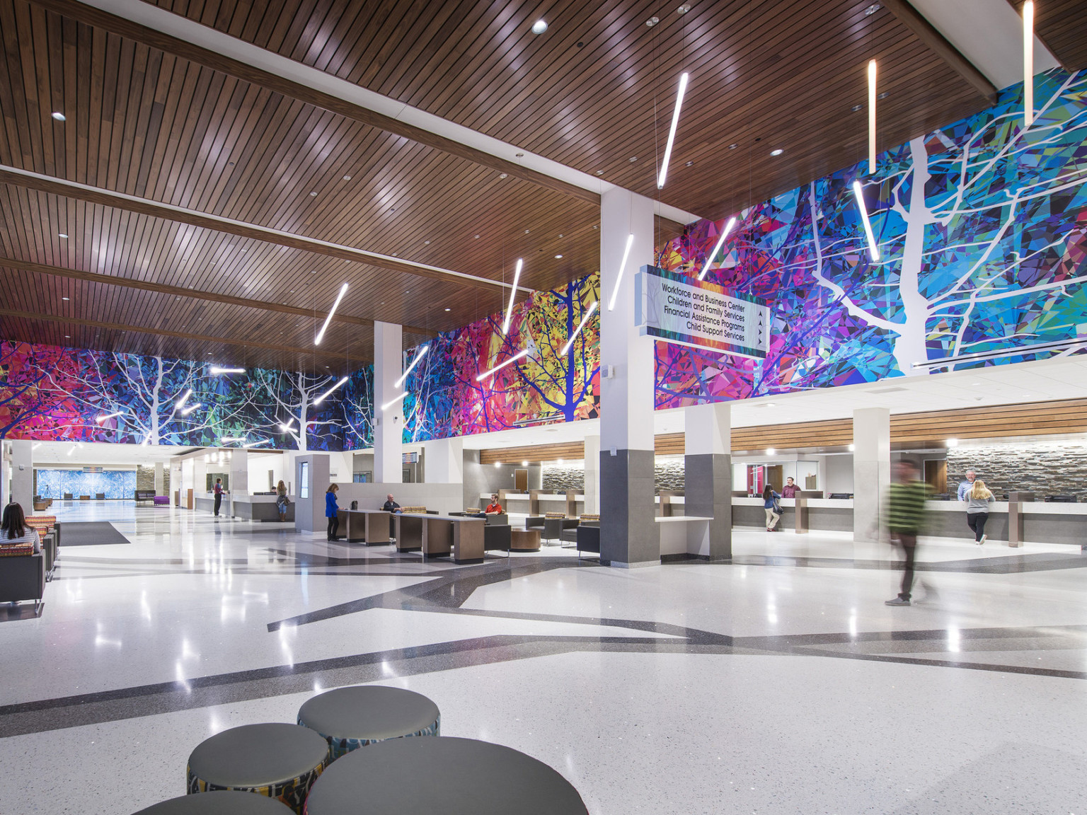 Colorful mural surrounds upper lobby wall in Adams County Pete Mirelez Human Services Center