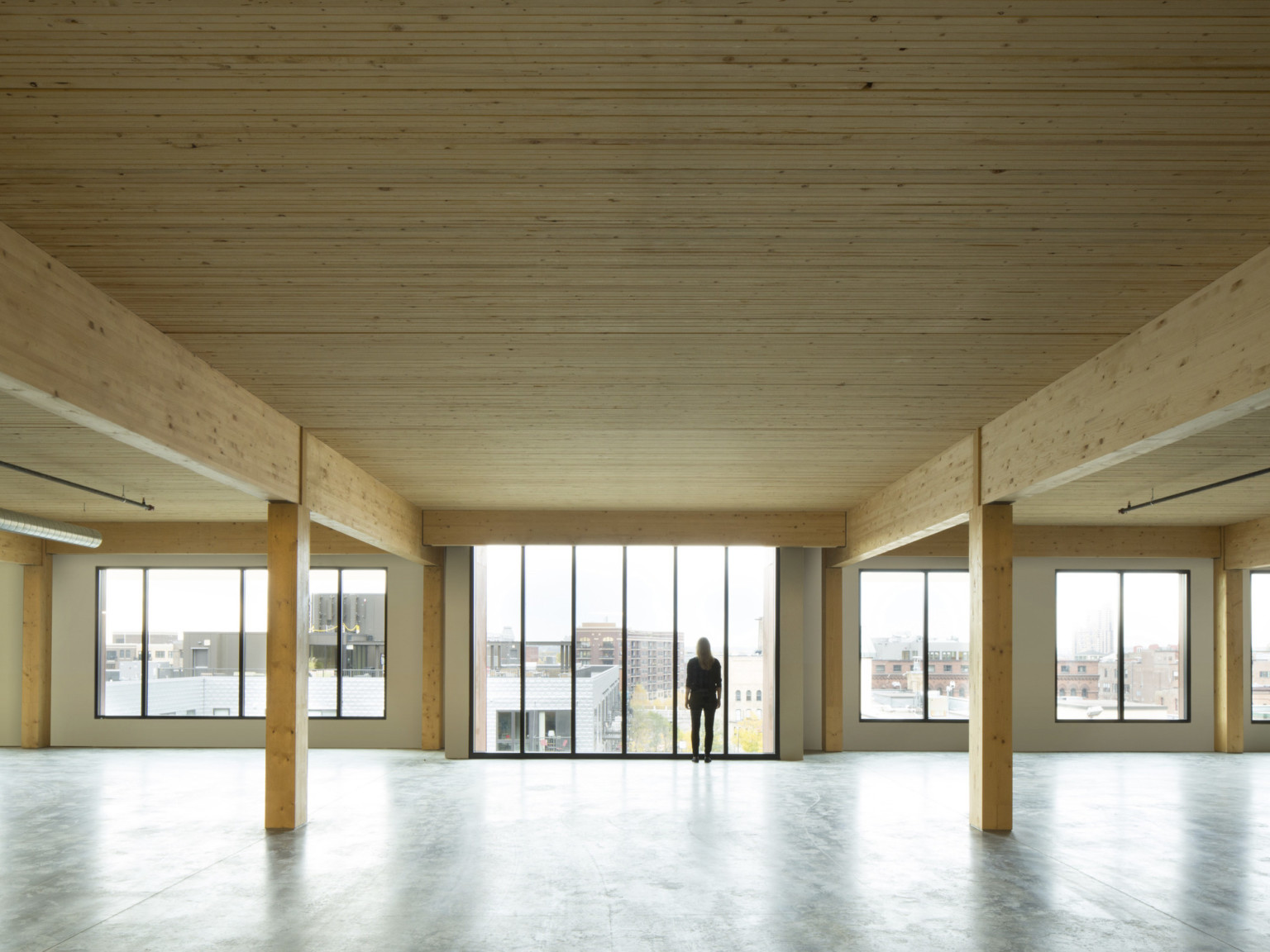 mass timber floor plate looking toward floor to ceiling windows mass timber floor plate looking toward floor to ceiling windows