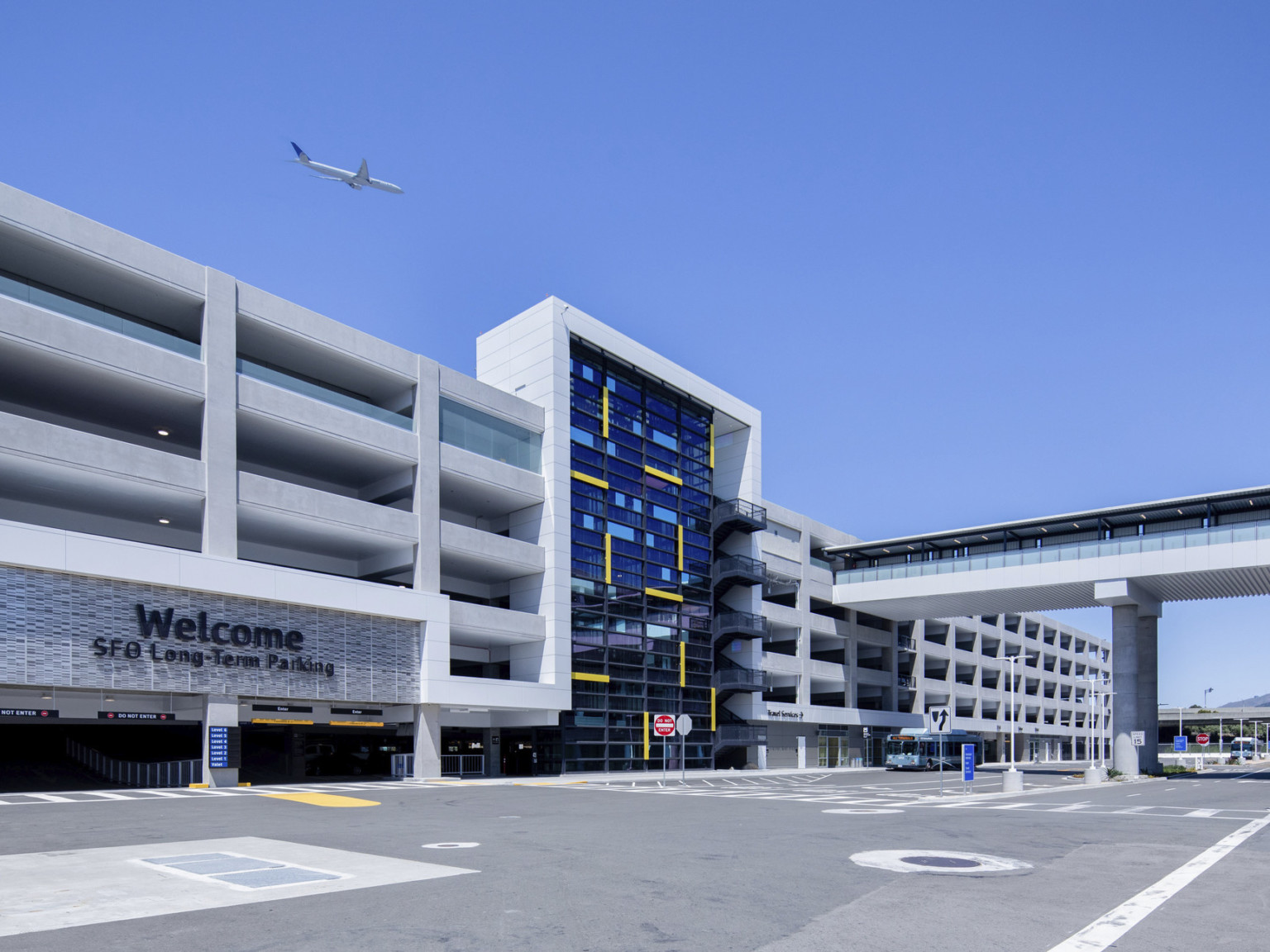 San Francisco International Airport Long Term Parking Garage, 6 stories with glass facade center and stairs. Entrance to left