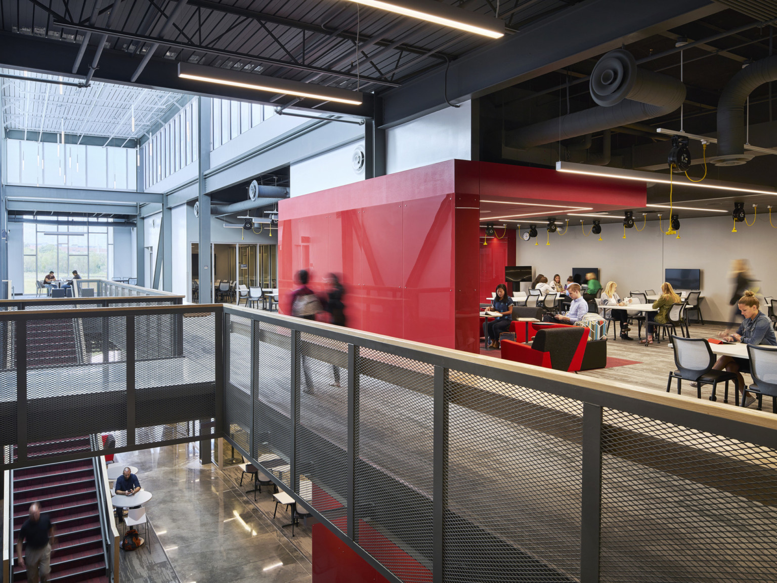 second floor collaboration learning area with breakout nodes and a large red architectural divider at the missouri innovation campus