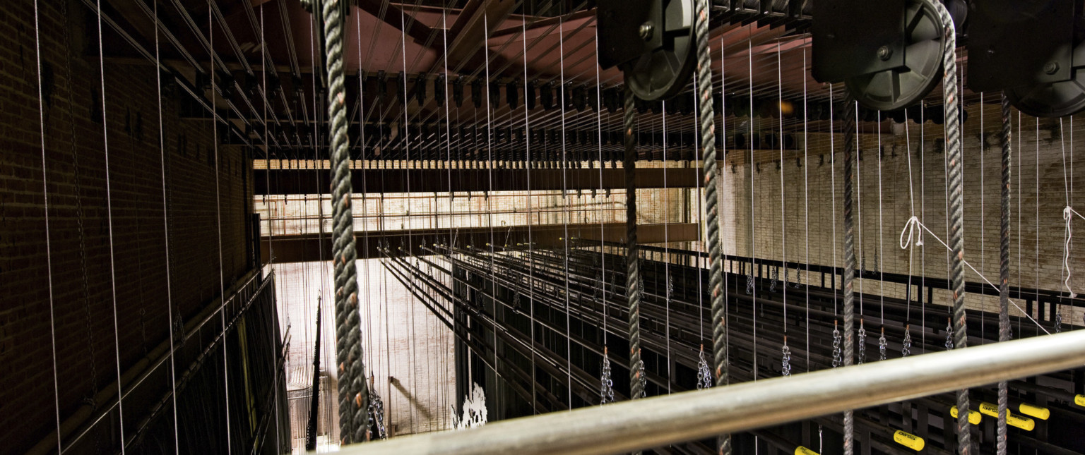 Closeup the lines of rope and cable in the rigging and fly system backstage