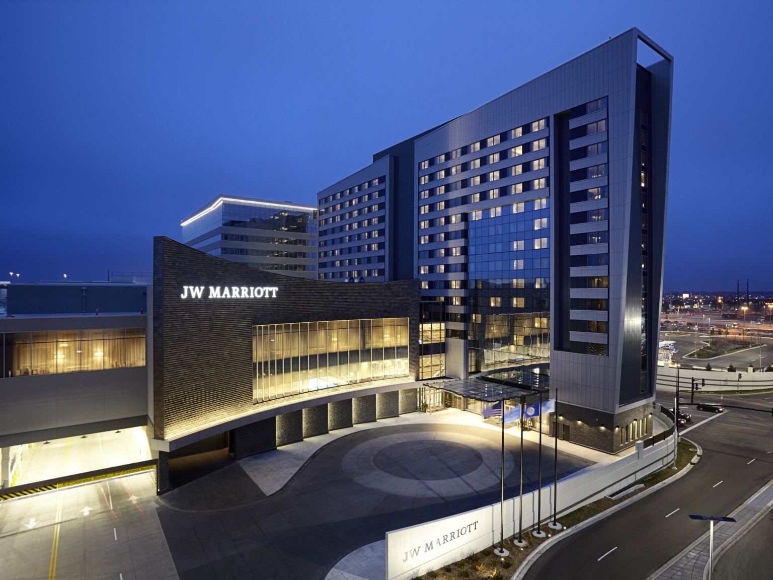 The JW Marriott Hotel and Mall of America illuminated at night. Sign lit on dark wall above double height windows The JW Marriott Hotel and Mall of America illuminated at night. Sign lit on dark wall above double height windows