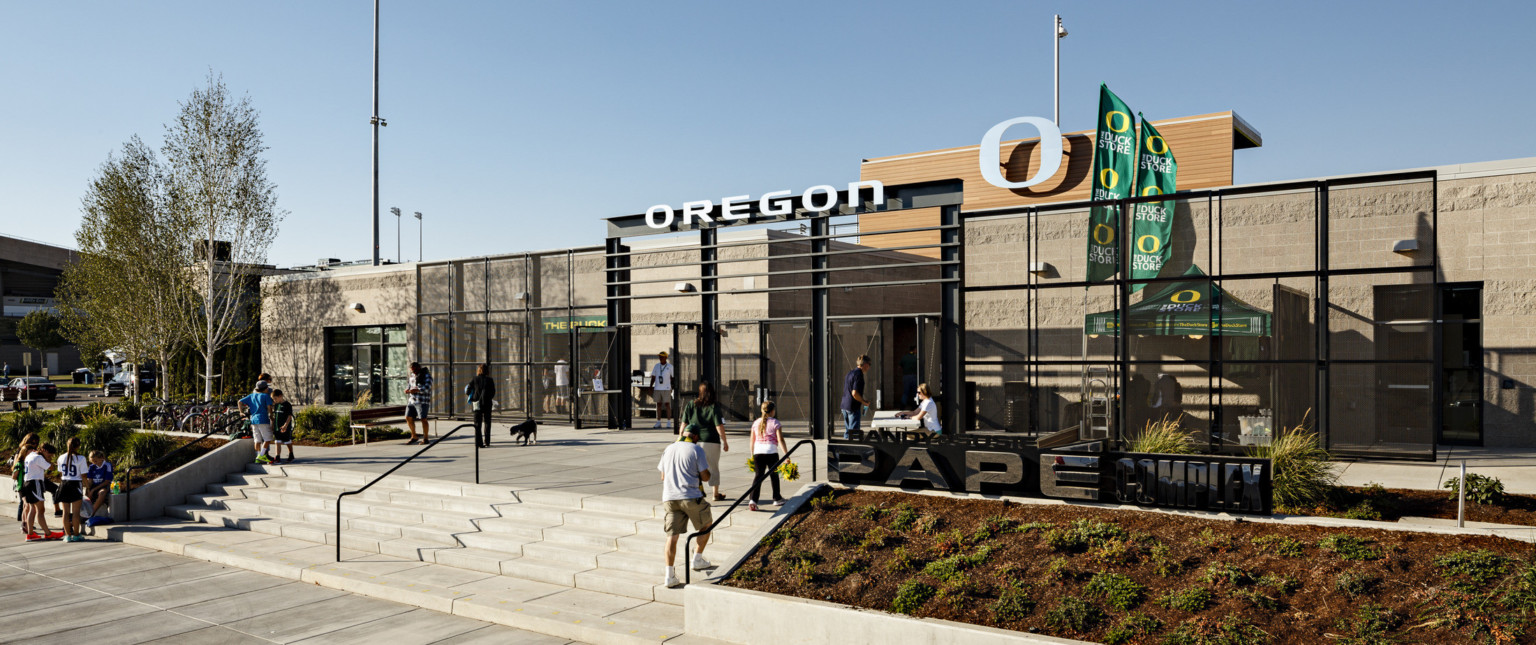 Papé Field entrance, 1 story concrete building with black gates surrounding exterior concession stands. Oregon logo at center