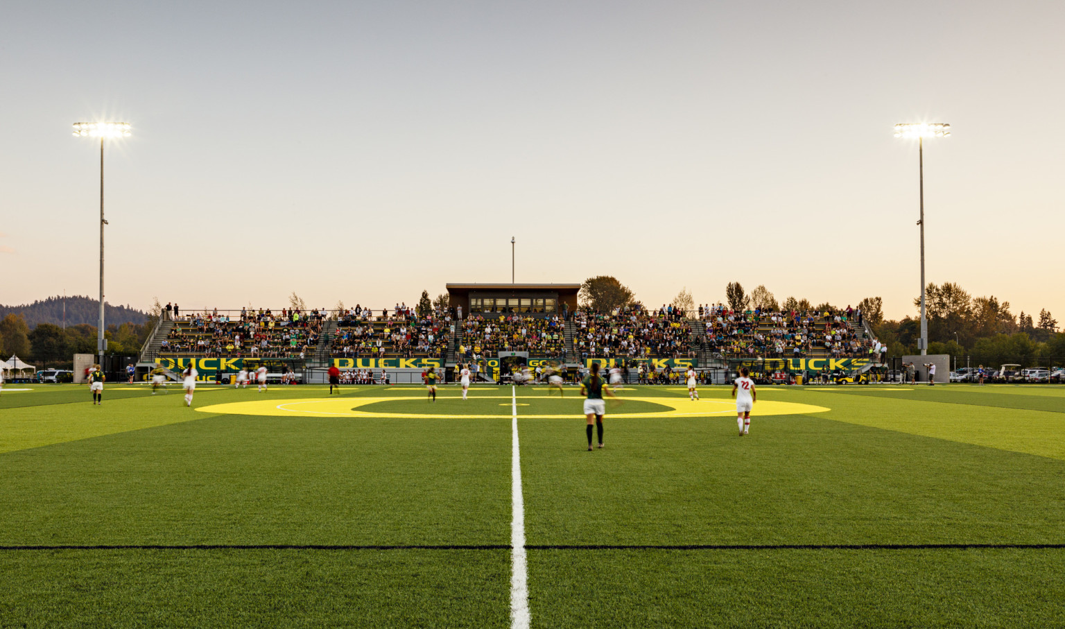 Papé Field, for University of Oregon womens soccer and lacrosse, seen from center line during game, bleachers reading Go Ducks
