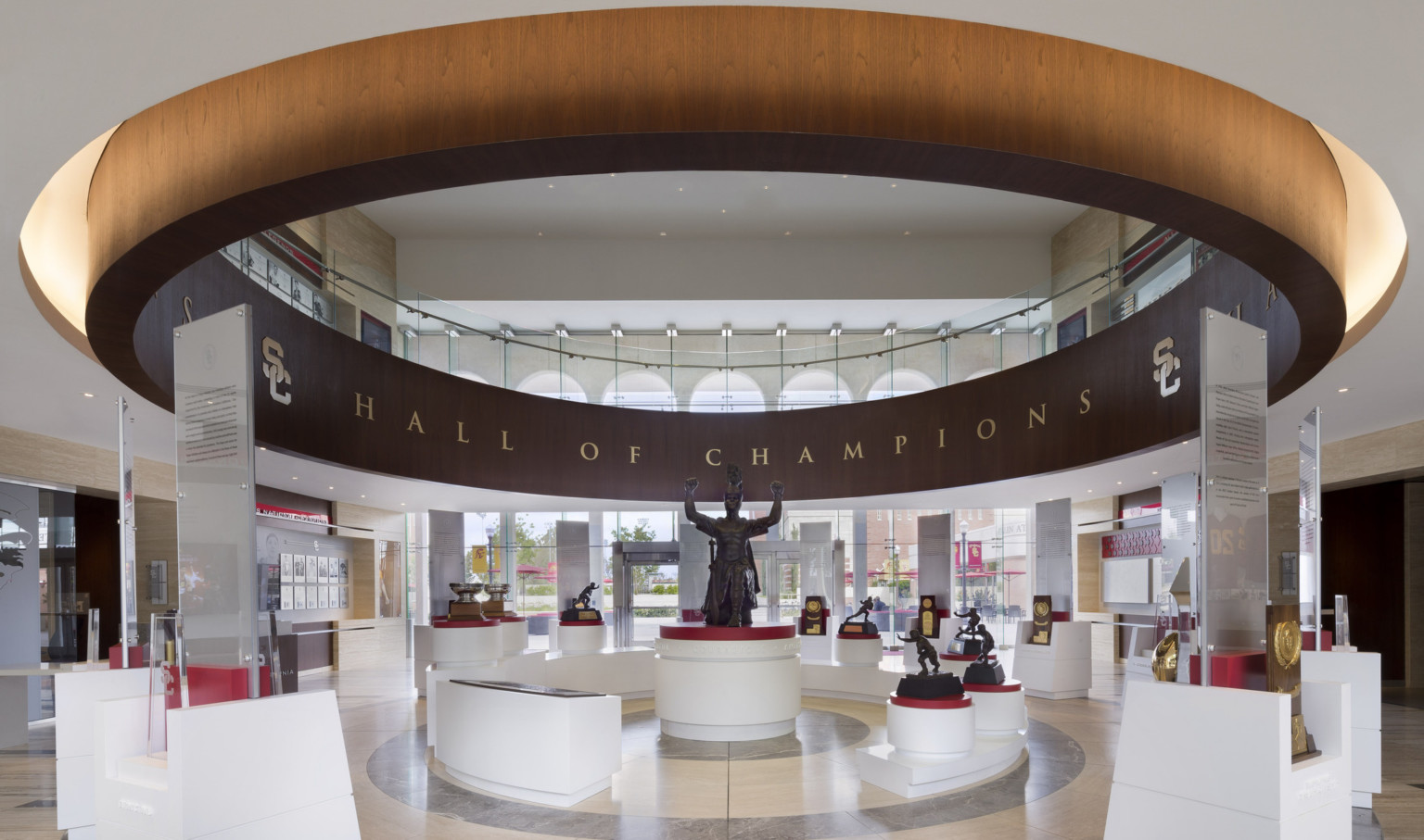 University of Southern California Heritage Hall interior, Spirit of Troy exhibit. Wood circle hangs around display and statue