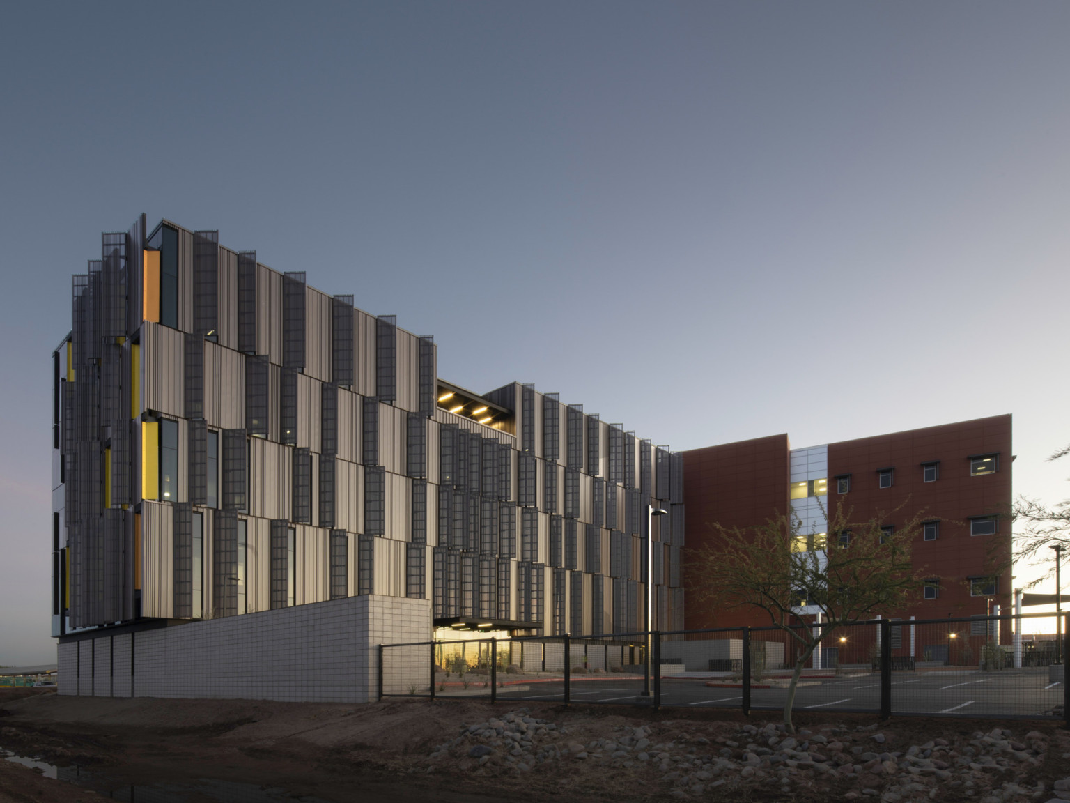 Dusk shot of Pinal County Attorney’s Offices, a serrated wrapped facade in alternating horizontal layers