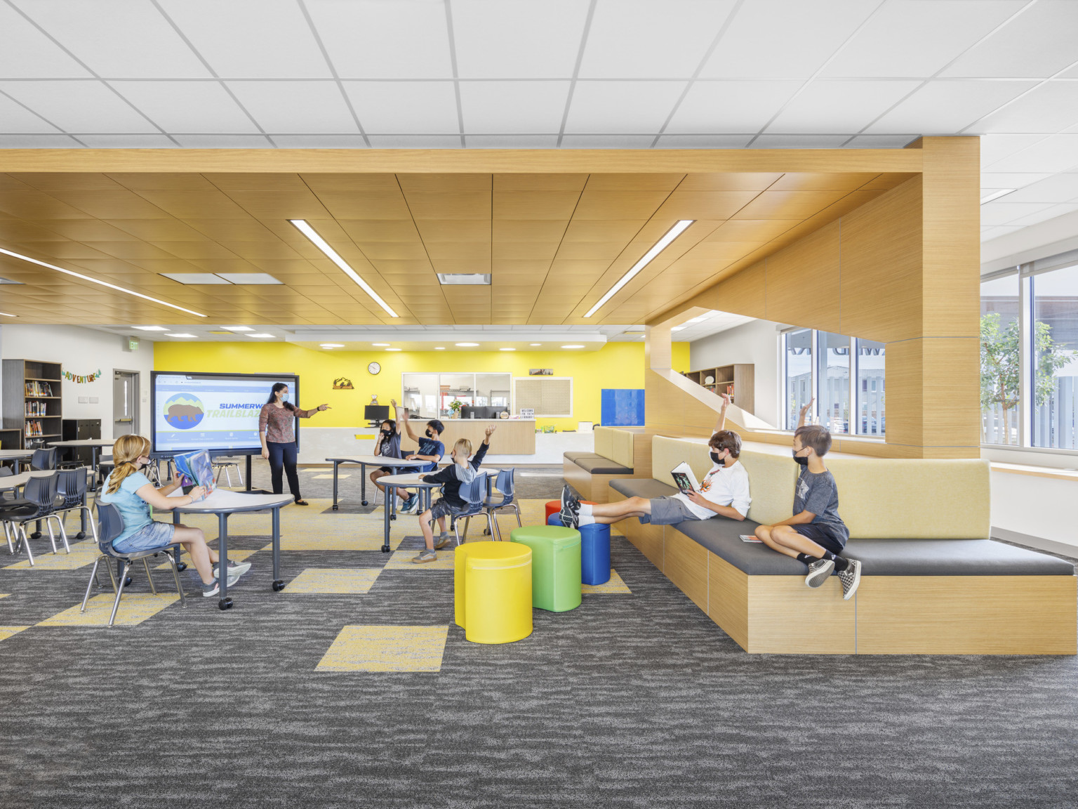 interior classroom with wood wrap ceiling accent around mixed flexible seating