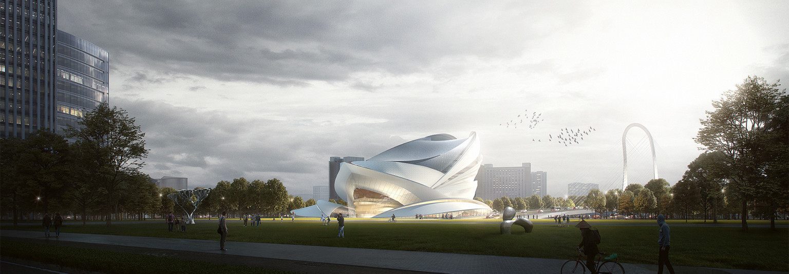 Theater viewed from across courtyard. Undulating white wrapped facade comes to a point at center over triple height glass.