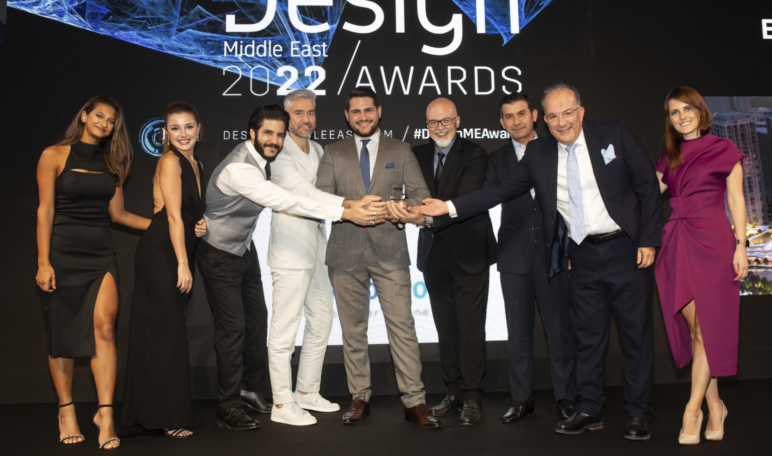 Design team from the DLR Group Dubai office at the Design Middle East awards with the trophy for Interior Design Firm of the Year