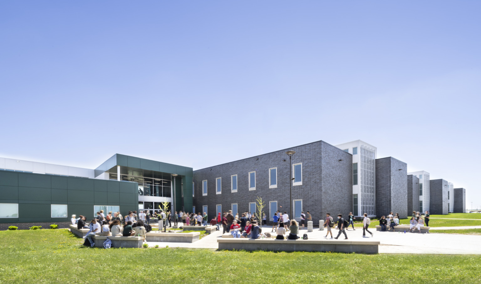 Exterior courtyard of Sioux Falls' Jefferson High School with wrapped facade square entry Exterior courtyard of Sioux Falls' Jefferson High School with wrapped facade square entry