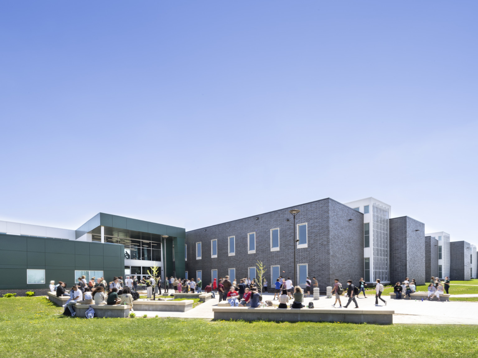 Exterior courtyard of Sioux Falls' Jefferson High School with wrapped facade square entry Exterior courtyard of Sioux Falls' Jefferson High School with wrapped facade square entry